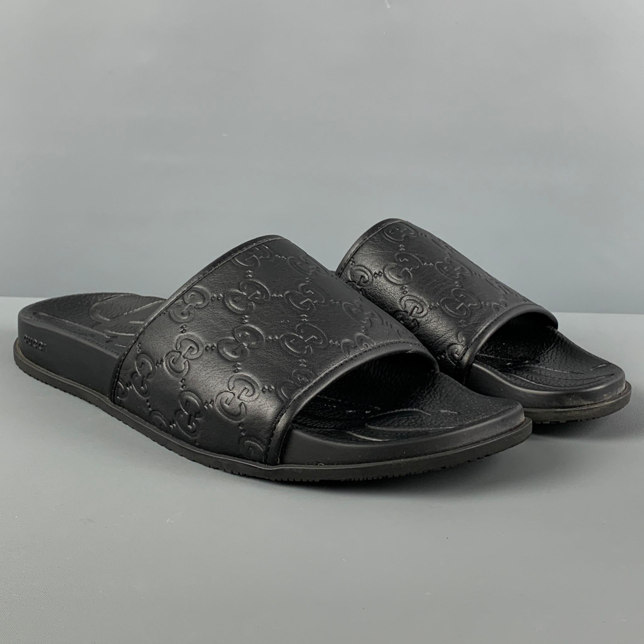 GUCCI slides comes in a black leather featuring a monogram design. Made in Italy.

Excellent Pre-Owned Condition.
Marked: 563695 45

Outsole: 12 in. x 4.75 in.

