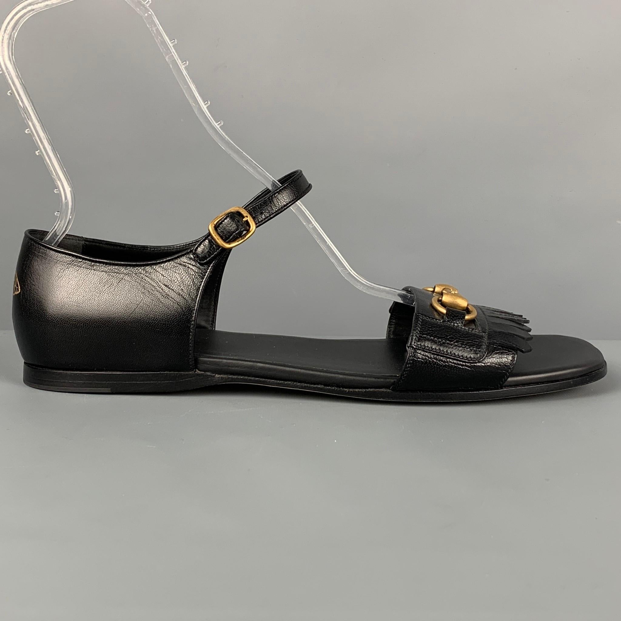 GUCCI sandals comes in a black leather featuring a horsebit detail, fringe trim, back heel bee design, and a ankle strap closure. Made in Italy. 

Excellent Pre-Owned Condition.
Marked: 12

Outsole: 12.25 in. x 4.5 in. 