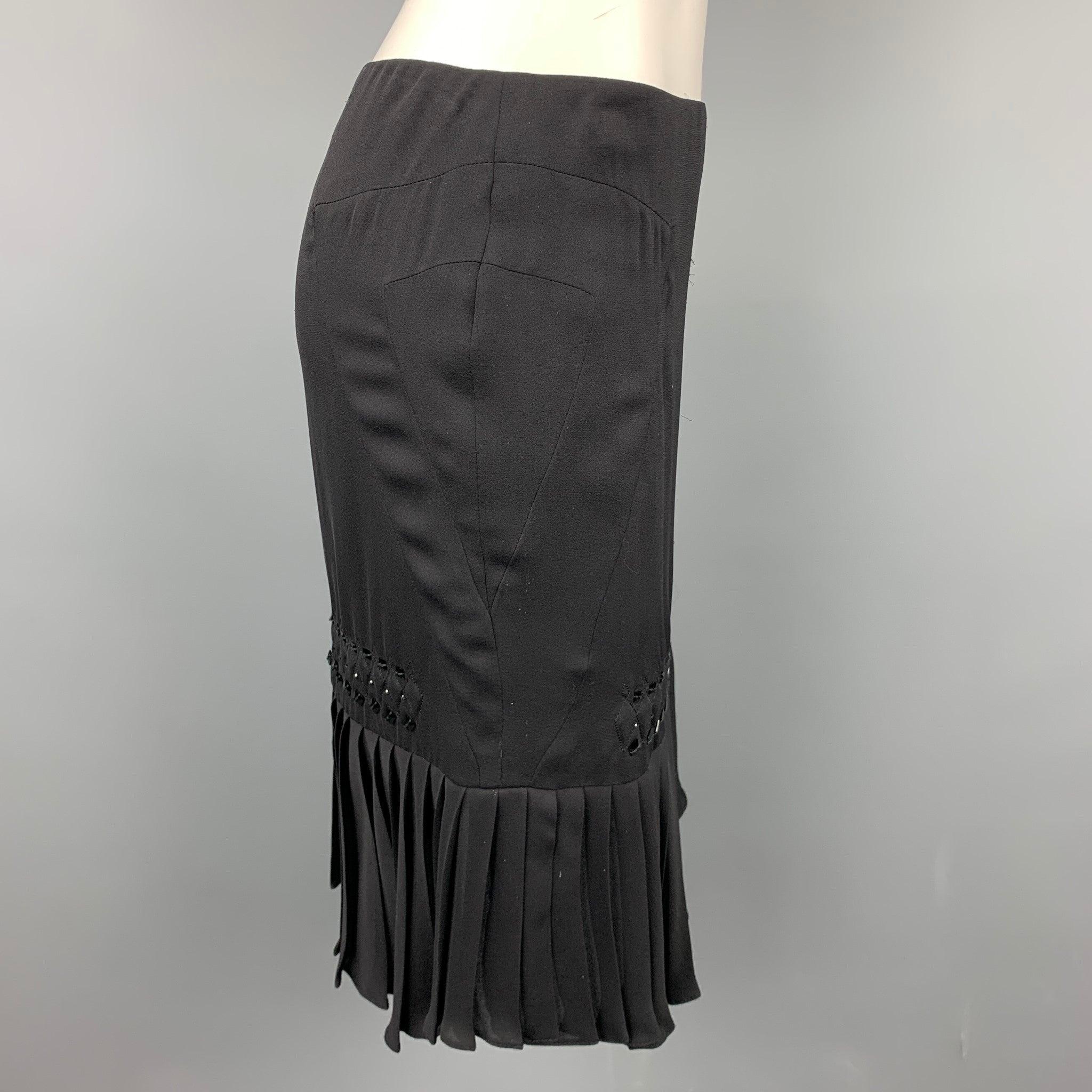 GUCCI skirt in a black silk with beaded details featuring a pleated style, top stitching, and a side zipper closure. Made in Italy.Excellent
Pre-Owned Condition. 

Marked:   IT 38 

Measurements: 
  Waist: 28 inches 
Hip: 34 inches Length: 21 inches