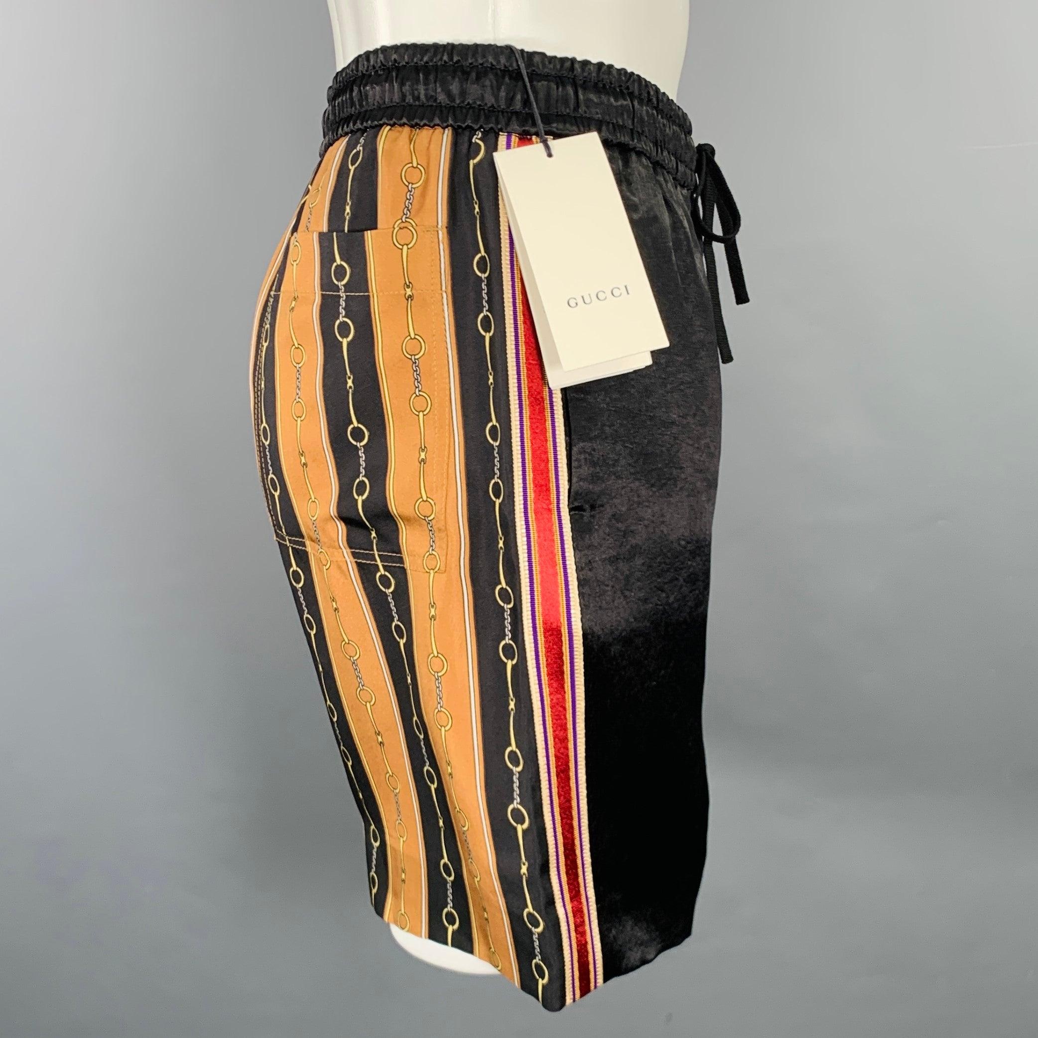 GUCCI by Alessandro Michele 2019 shorts in a gold tone and black acetate and silk featuring a joggers style, horsebit stripe patterned back, and drawstring closure. Made in Italy.New with Tags. 

Marked:   IT 44 

Measurements: 
  Waist: 28 - 32