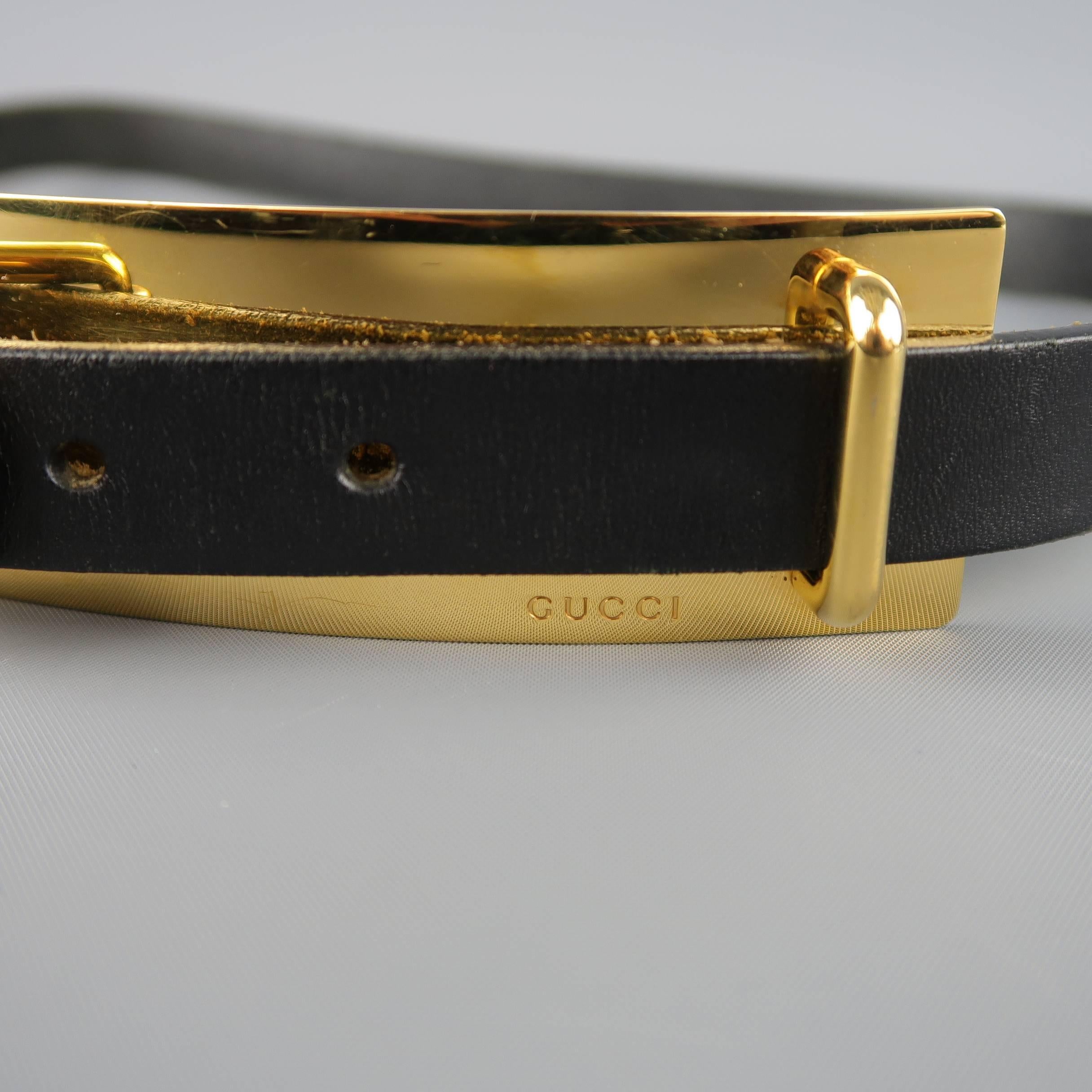 GUCCI belt comes in black leather with an oversized gold tone metal plate detail with buckle. Wear throughout. As-is. Made in Italy.
 
Fair Pre-Owned Condition.
Marked: 90
 
Length: 44 in.
Width: 1 in.
Fits: 33.37 in.
Buckle: 7.75 x 1.5 in.
