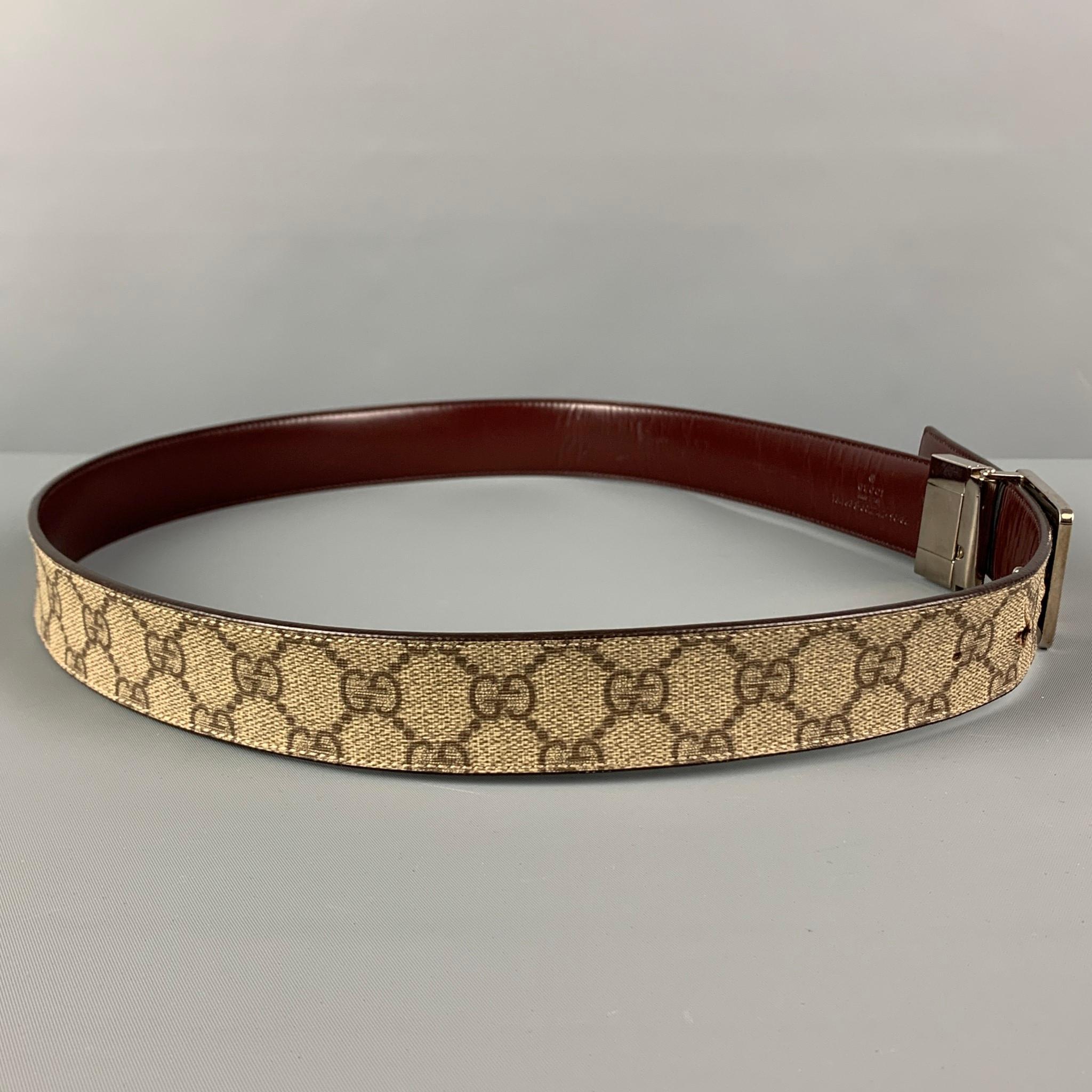 GUCCI belt comes in a beige & brown 'Guccisima' print coated canvas featuring reversible burgundy leather style and a silver tone logo buckle closure. Made in Italy.

Very Good Pre-Owned Condition.
Marked: 154633-502742-90-36

Length: 39.5
