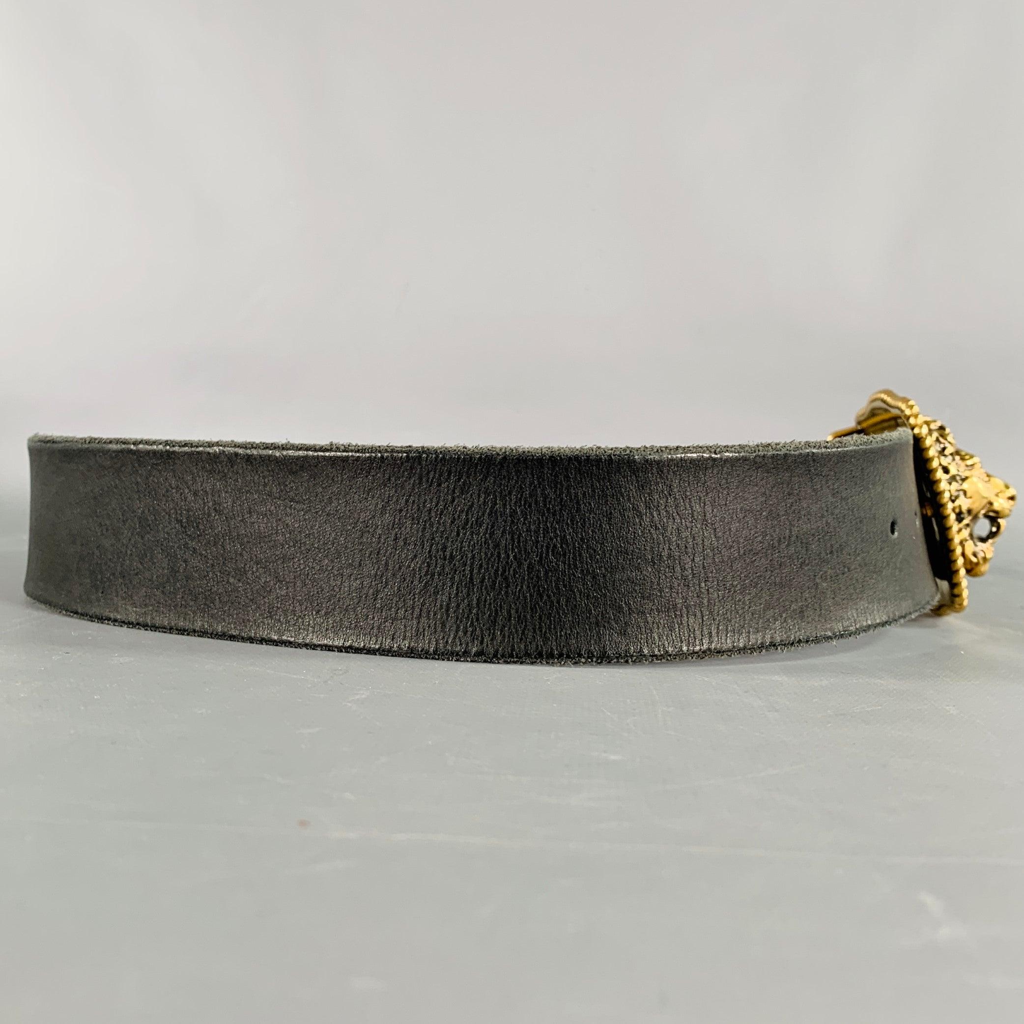 GUCCI belt
in a black leather featuring a stunning gold tone metal Lion's head buckle. Comes with dust bag. Made in Italy.Excellent Pre-Owned Condition. 

Marked:   587800 CVE0T 90 36 493949Length: 40.5 inches Width: 1.75 inches Fits: 34 inches  -