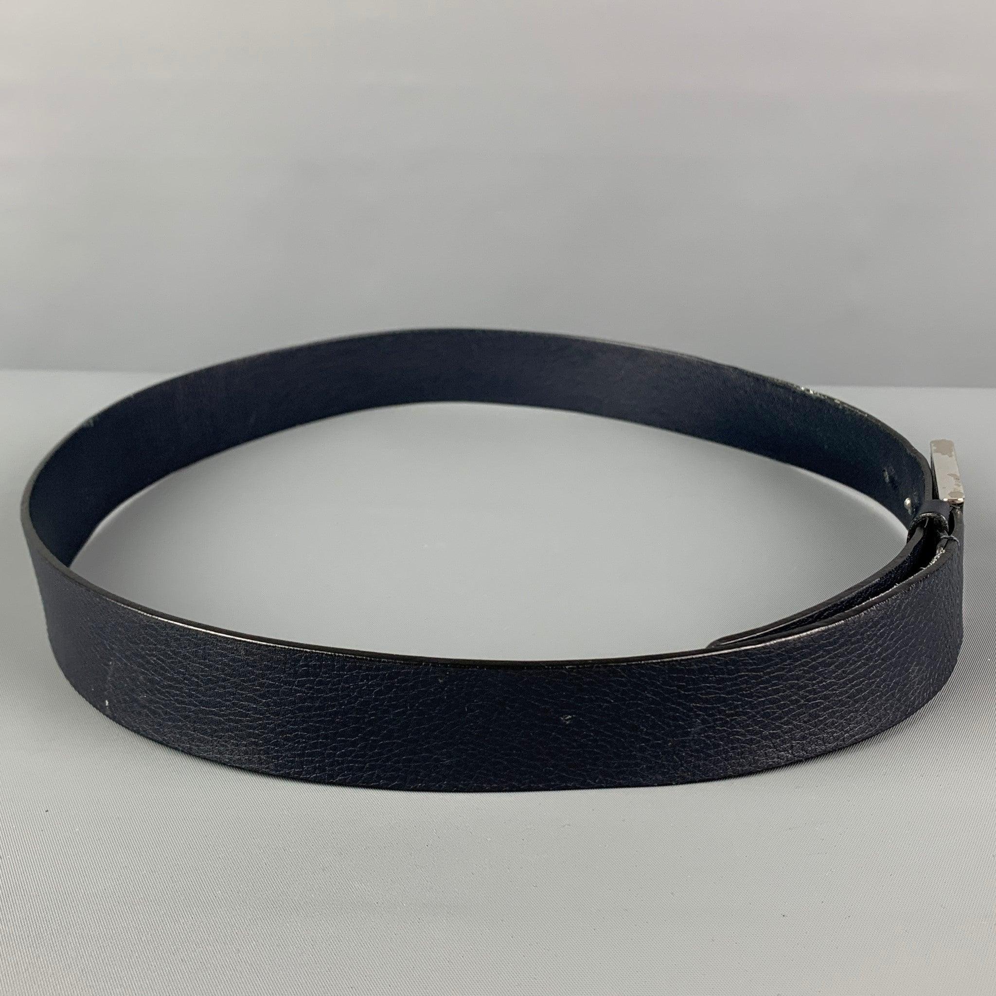 GUCCI belt comes in a navy textured leather featuring a covered buckle closure. Made in Italy.
 Very Good
 Pre-Owned Condition. 
 

 Marked:  368188 A7M0N 95-38 1766Length: 42 inches Width: 1.25 inches Fits: 36.5 inches - 40.5 inches Buckle: 2.25