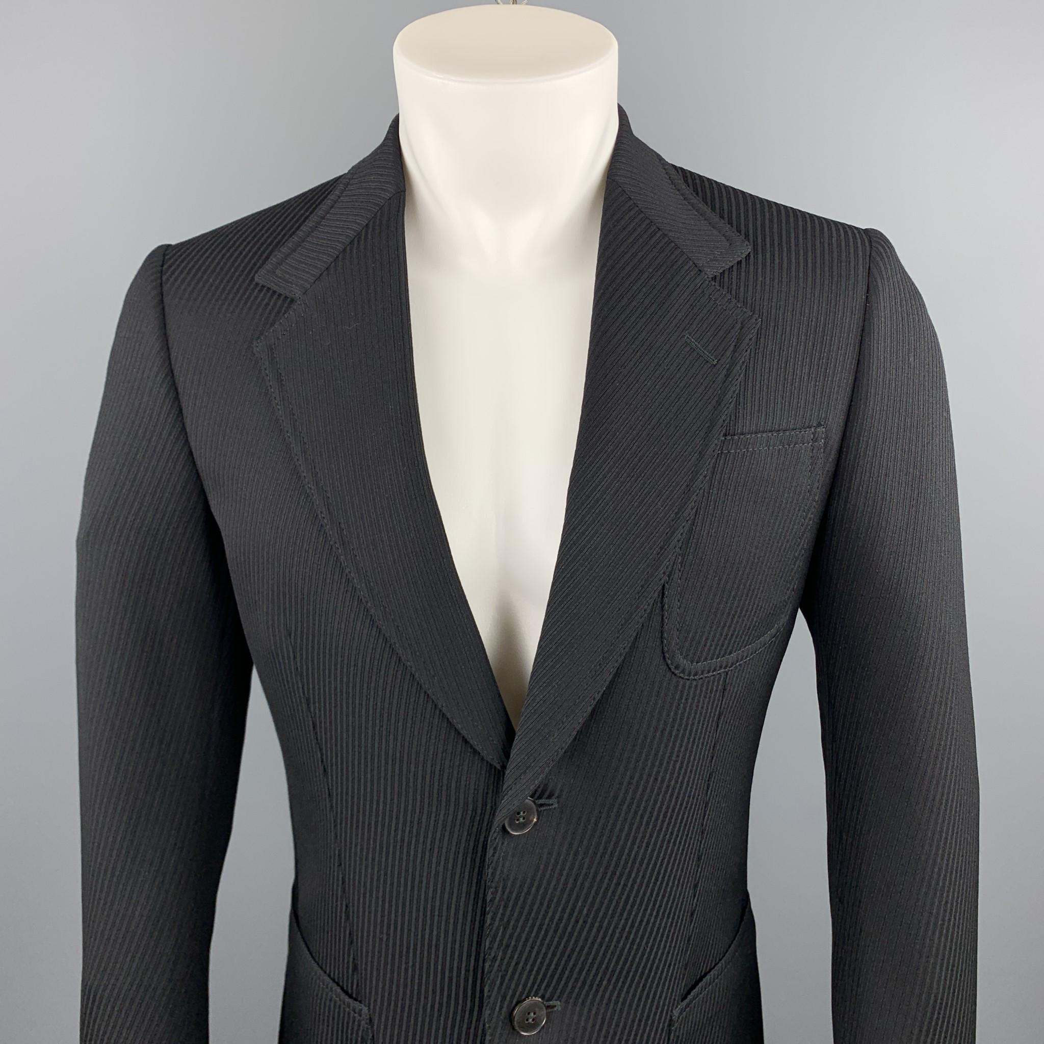 GUCCI sport coat comes in a black textured wool featuring a notch lapel style, patch pockets, printed liner, and a two button closure. Made in Italy.

Excellent Pre-Owned Condition.
Marked: IT 48

Measurements:

Shoulder: 16 in. 
Chest: 38 in.