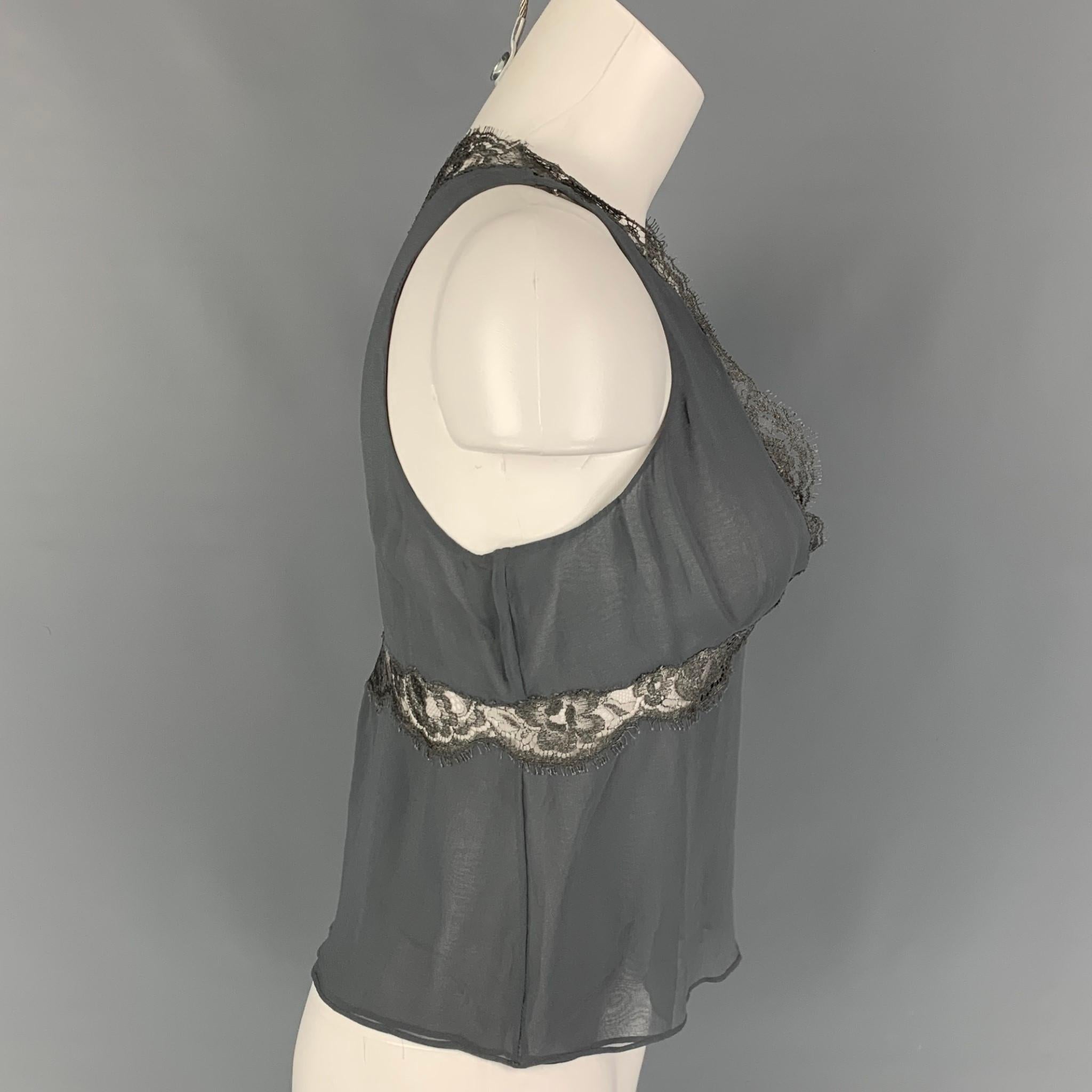 GUCCI camisole dress top comes in a grey silk featuring a lace trim, v-neck, sleeveless, and a side zipper closure. Made in Italy. 

Very Good Pre-Owned Condition.
Marked: 40

Measurements:

Shoulder: 10 in.
Bust: 30 in.
Length: 20.5 in. 