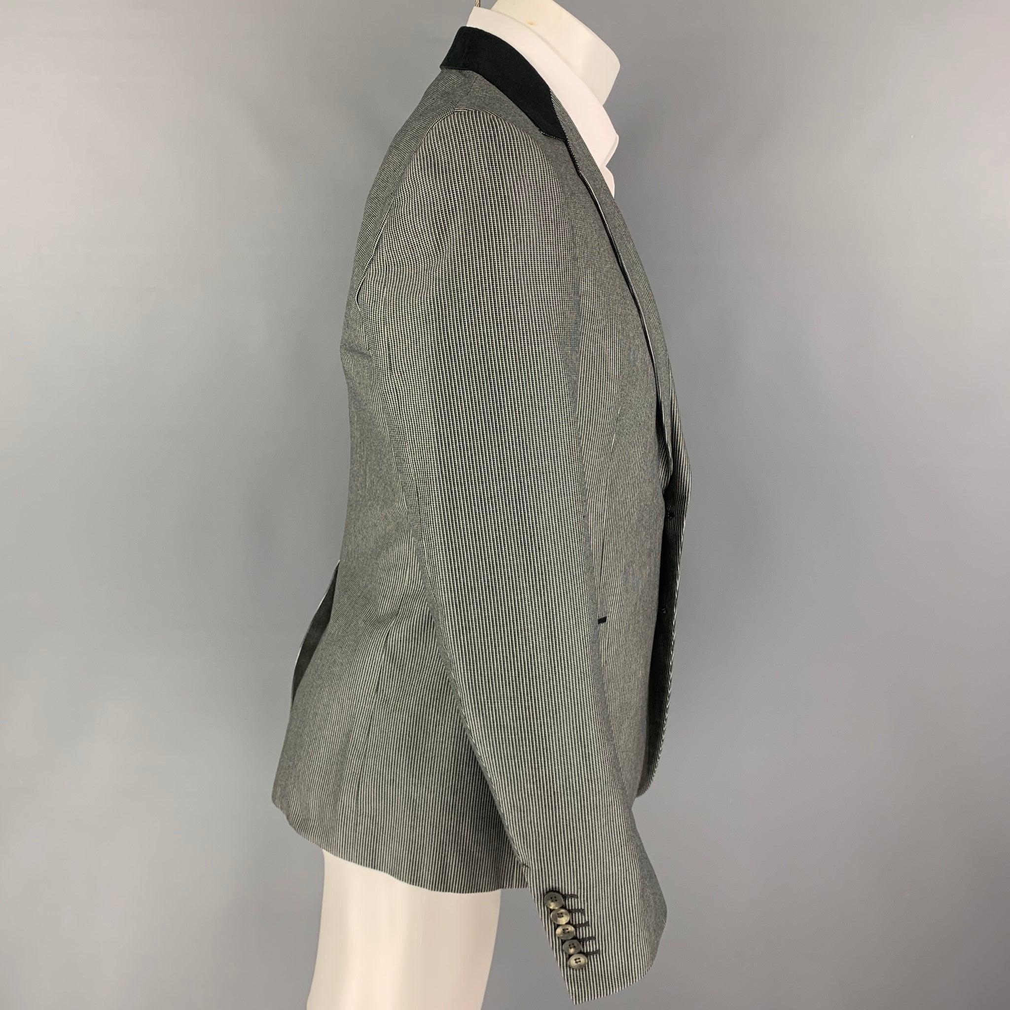 GUCCI sport coat comes in a black & white stripe cotton with a full liner featuring a notch lapel, flap pockets, single back vent, and a double button closure. Made in Italy.
Excellent
Pre-Owned Condition. 

Marked:   50 R  

Measurements: 
