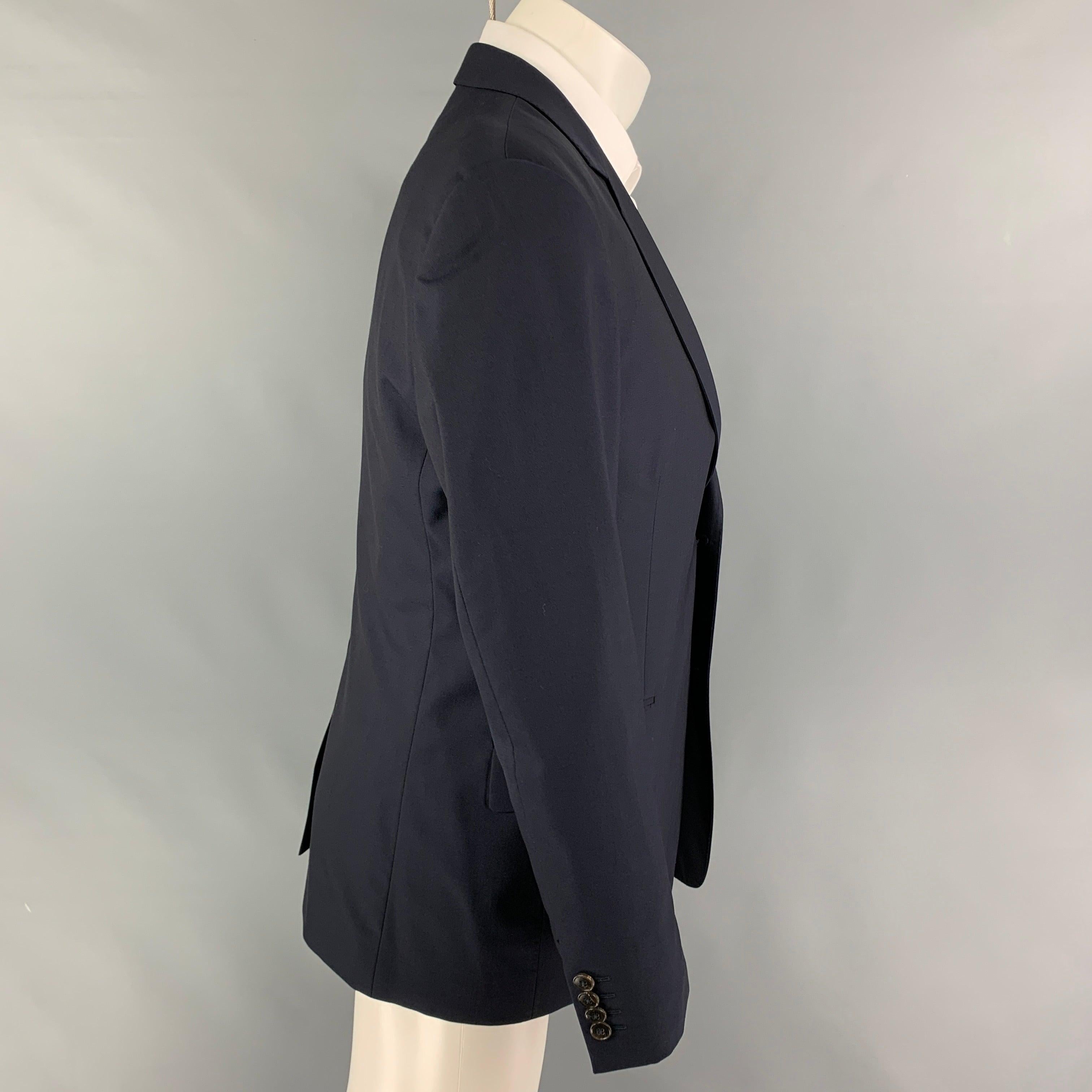 GUCCI sport coat comes in a navy wool with a full liner featuring a notch lapel, flap pockets, single back vent, and a double button closure. Made in Italy.
Very Good
Pre-Owned Condition.  

Marked:   50 R  

Measurements: 
 
Shoulder: 18 inches 