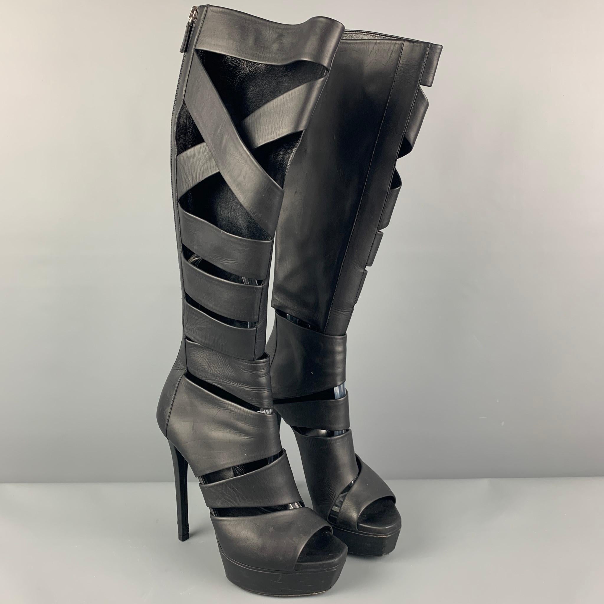 GUCCI 'Helena' boots comes in a black leather featuring cut-out designs, knee high, platform, and a stiletto heel. Made in Italy. 

Very Good Pre-Owned Condition.
Marked: 36
Original Retail Price: $1,650.00

Measurements:

Heel: 5 in.
Platform: 1