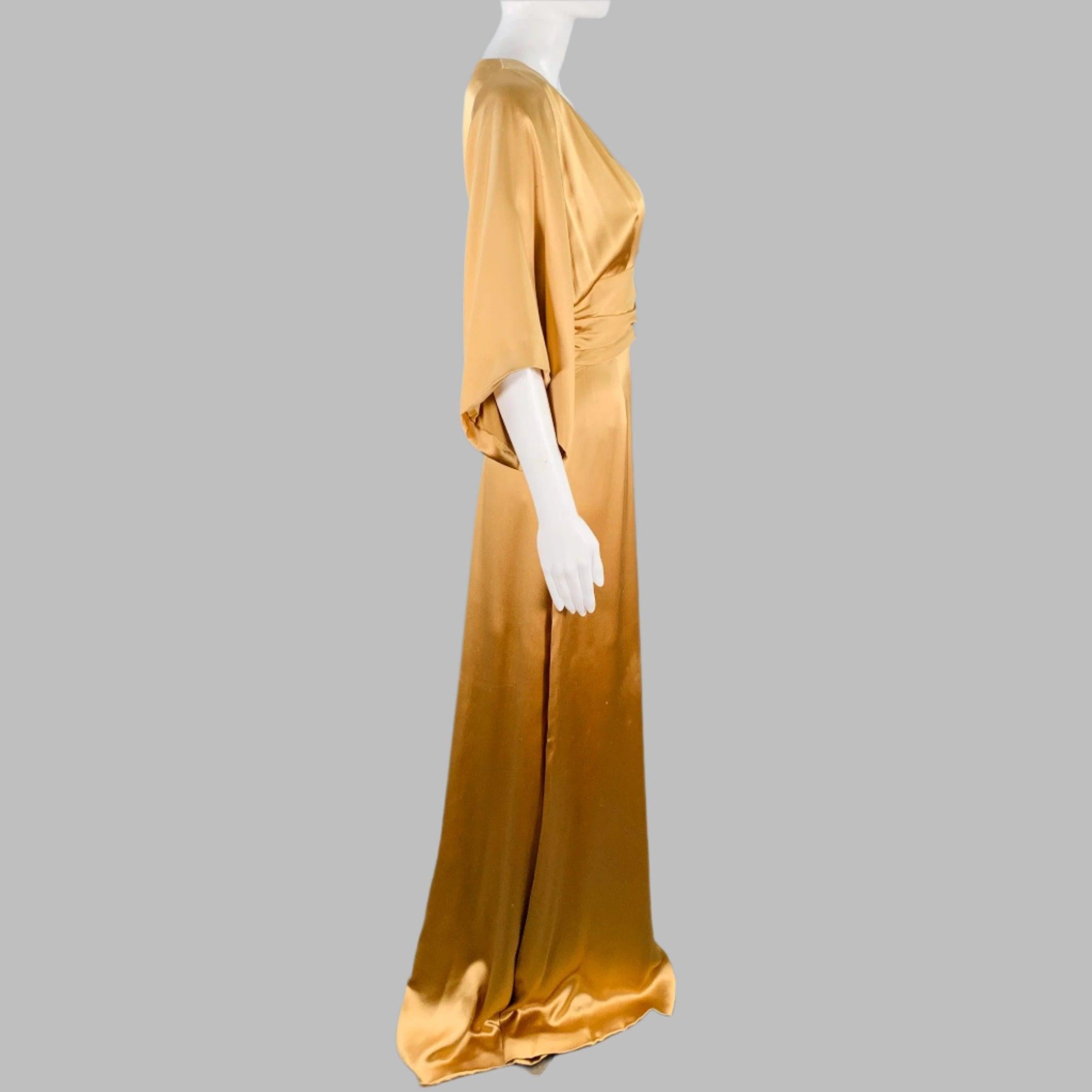 GUCCI evening gown
in a gold tone silk featuring a ruched bodice, short sleeves, and V-neck. Made in Italy.Good Pre-Owned Condition. Moderate snags and signs of wear, as is. 

Marked:   IT 42 

Measurements: 
 
Shoulder: 13 inches Bust: 32 inches