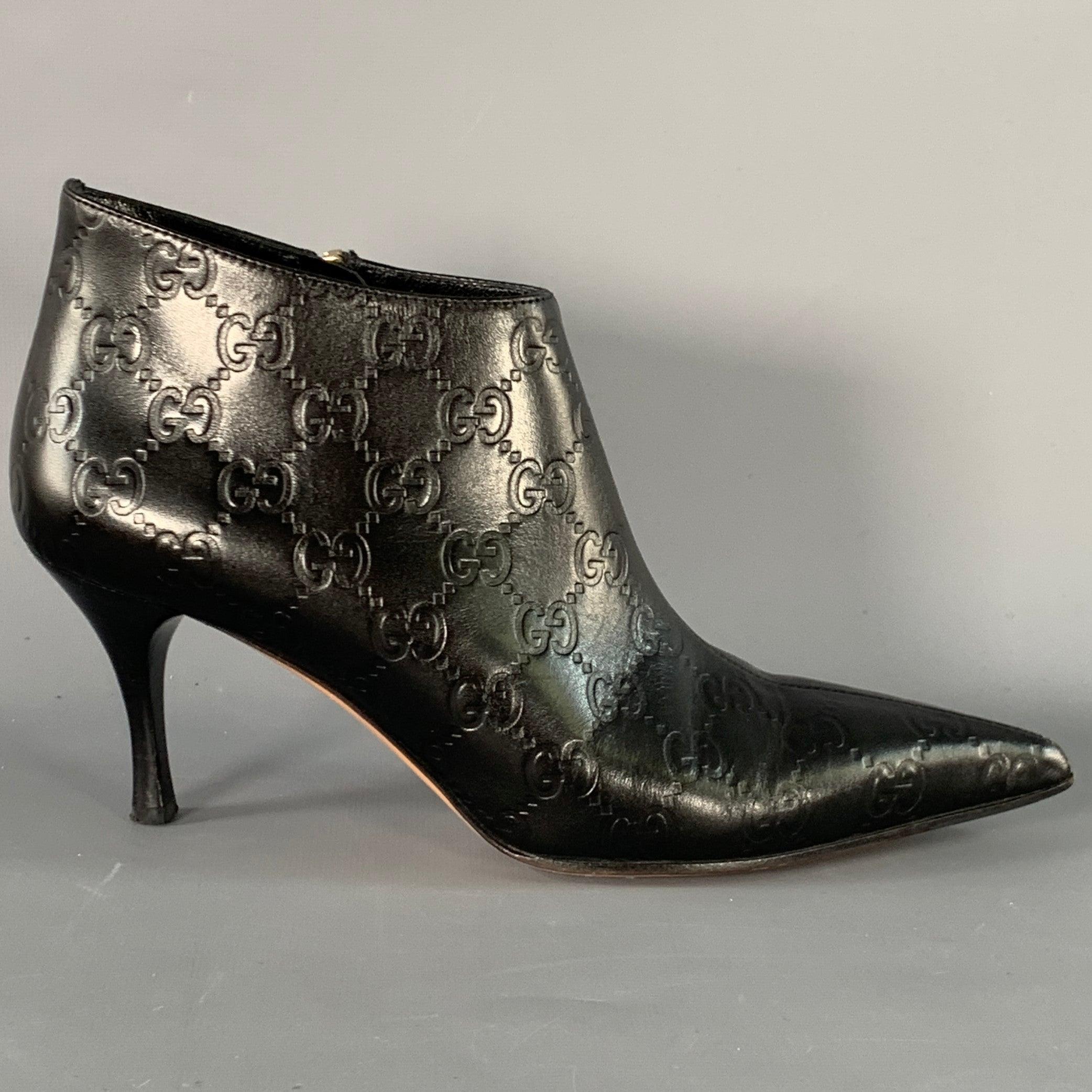 GUCCI
boots in a black leather featuring an embossed Guccissima monogram pattern, pointed toe, and side zipper closure. Comes with box. Made in Italy.Very Good Pre-Owned Condition. Signs of wear on soles. 

Marked:   146754 6 BLength: 9.5 inches