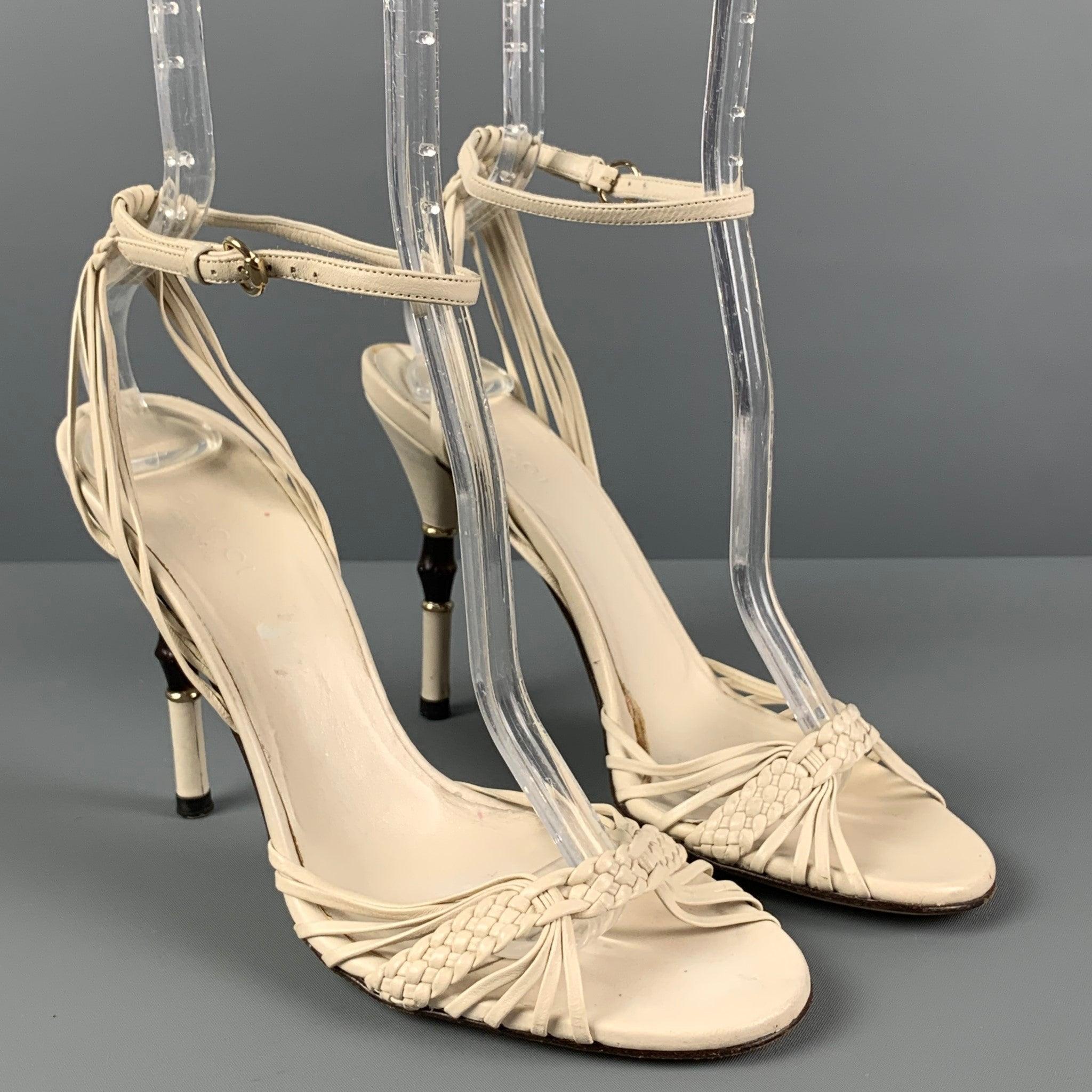 GUCCI sandals comes in a white woven leather featuring a ankle strap, open toe, and a bamboo heel. Made in Italy.
 Good
 Pre-Owned Condition. Moderate wear throughout. As-Is.  
 

 Marked:  6.5 B  
 

 Measurements: 
  Heel:
 4 inches  
  
  
  
