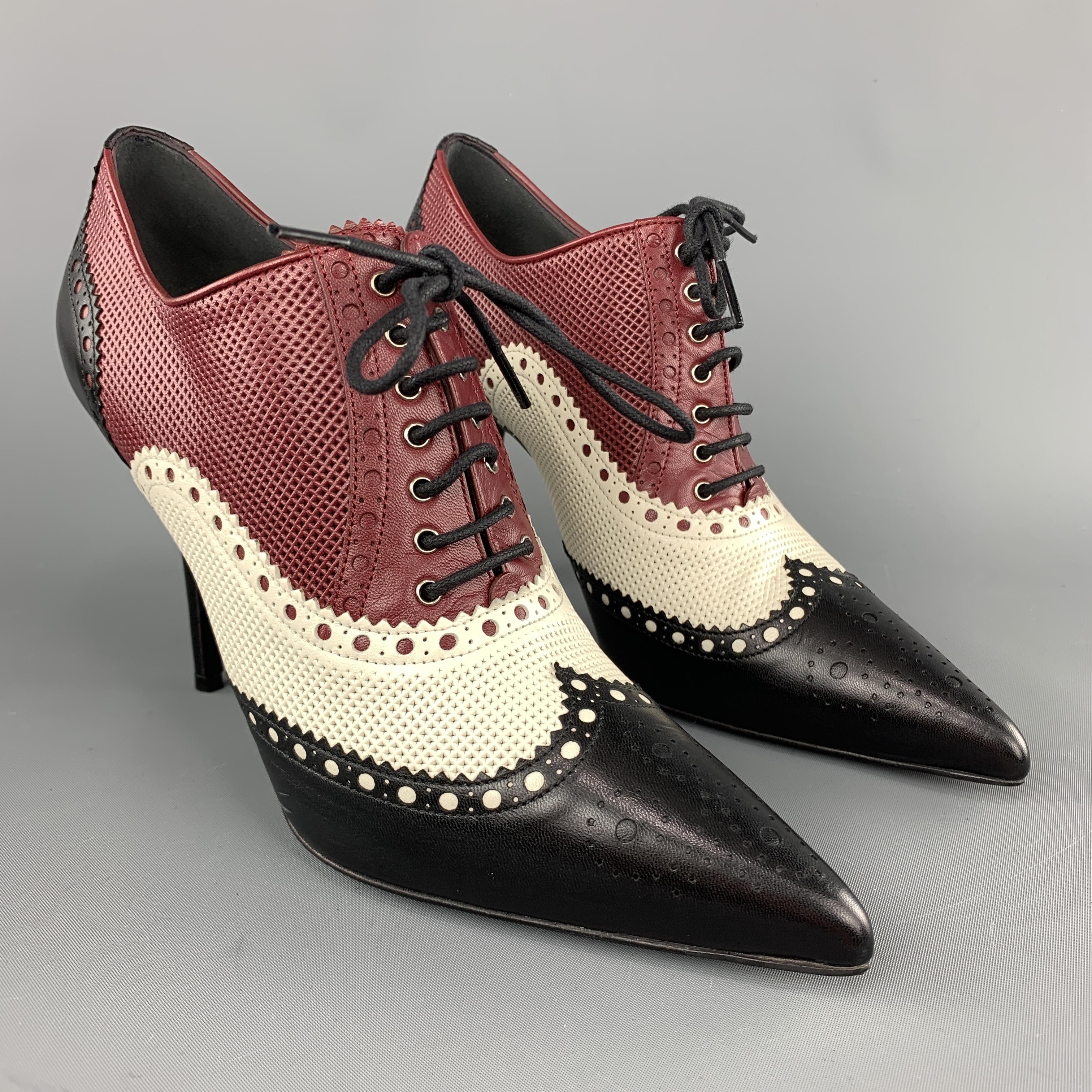 GUCCI oxford booties come in black, burgundy, and cream perforated color block leather with a pointed toe, lace up front, and broguing. Made in Italy.

Excellent Pre-Owned Condition. Retails: $1,100.00.
Marked: IT 38