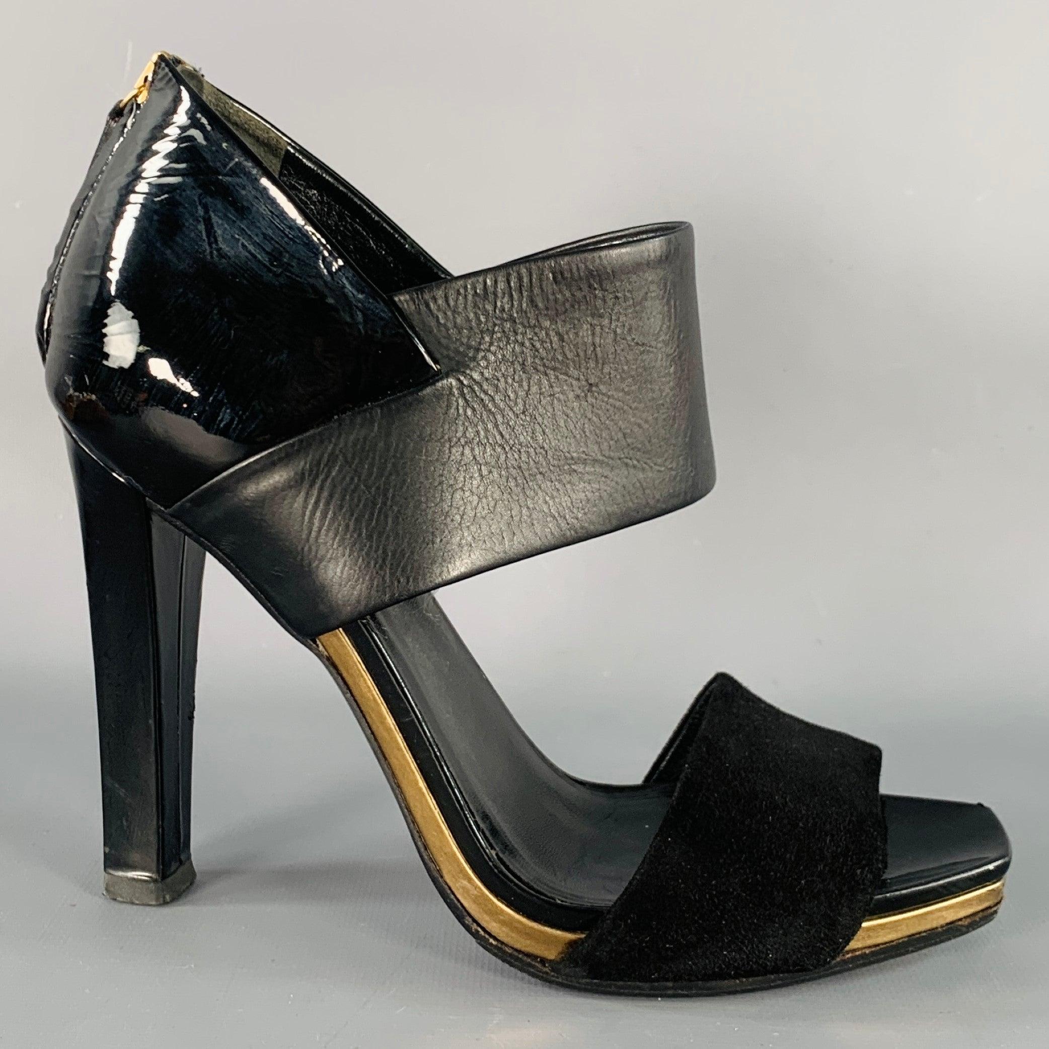GUCCI sandals
in a black mixed leathers (suede, leather, and patent leather) featuring a metallic gold tone stripe detail, and back zipper closure. Note: these shoes have been resoled with a slip resistant material. Made in Italy.Good Pre-Owned