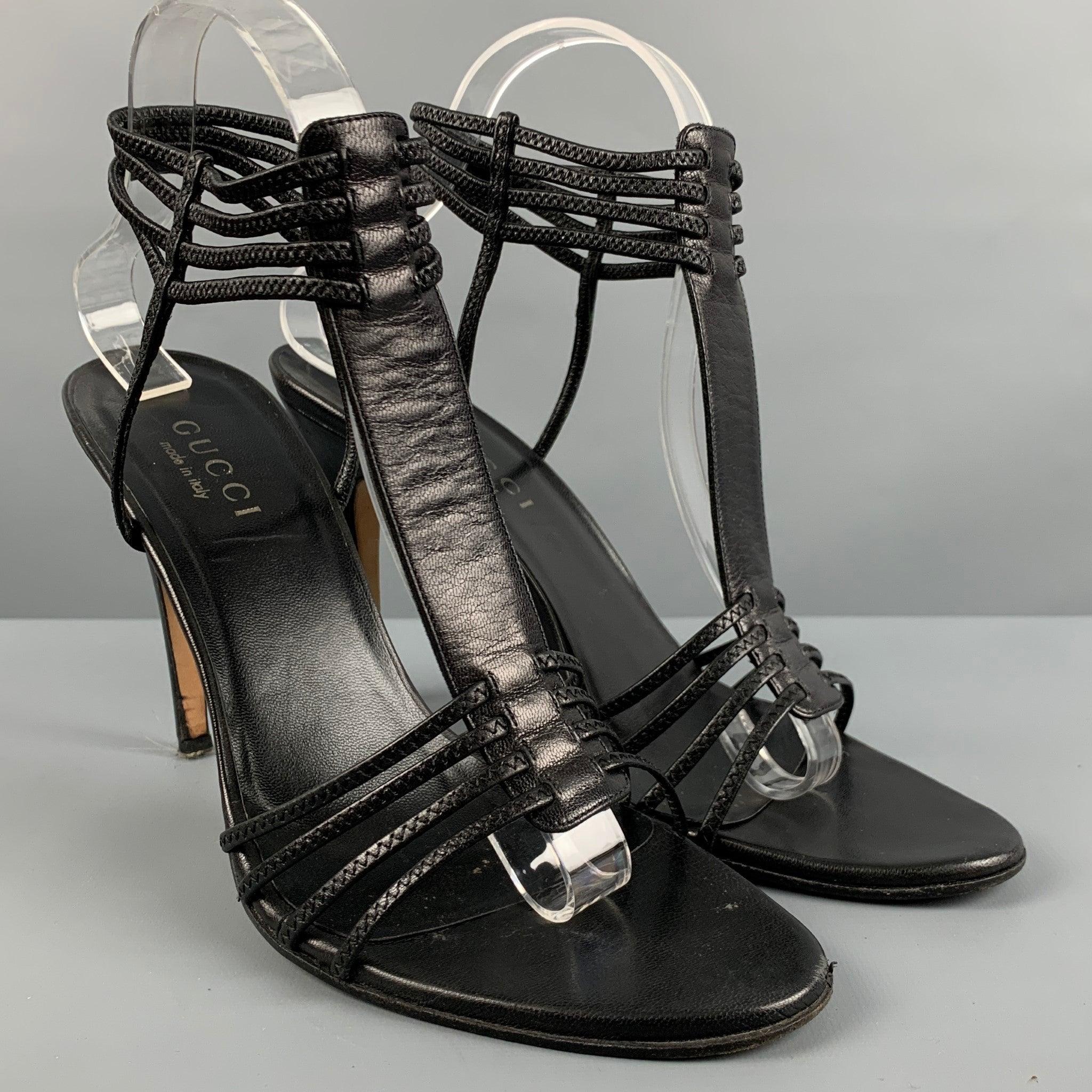 GUCCI sandals comes in a black leather featuring a strappy style. Comes with the box, dust bag, and extra heel replacement tips. Made in Italy.Very Good Pre-Owned Condition. Minor signs of wear. 

Marked:   091043 9B 

Measurements: 
  Heel: 4.25