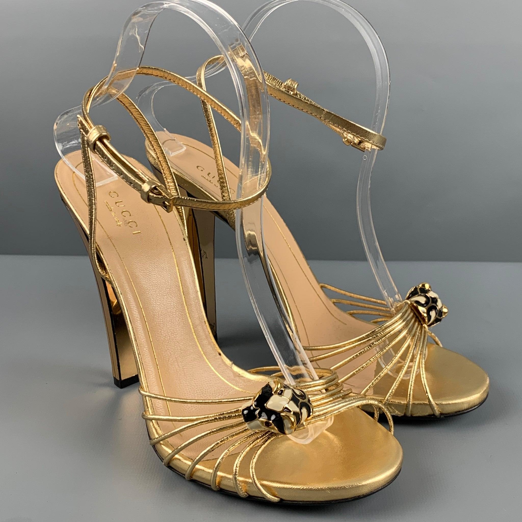 GUCCI ORO sandals comes in a gold leather featuring a open toe, ankle strap, mirrored heel, and feline gold tone metal detail. Comes with the box and dust bag. Made in Italy. Very Good Pre-Owned Condition. Moderate signs of wear. 

Marked:   39