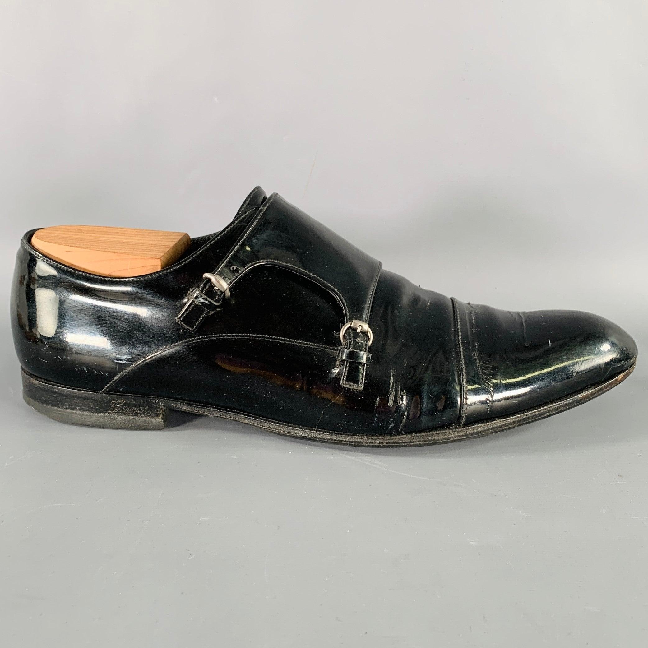 GUCCI shoes
in a black patent leather featuring a cap toe, and lace-up closure with double monk strap. Shoe trees not included. Comes with box. Made in Italy.Very Good Pre-Owned Condition with Box. Moderate creasing and cracking, as is. 

Marked:  