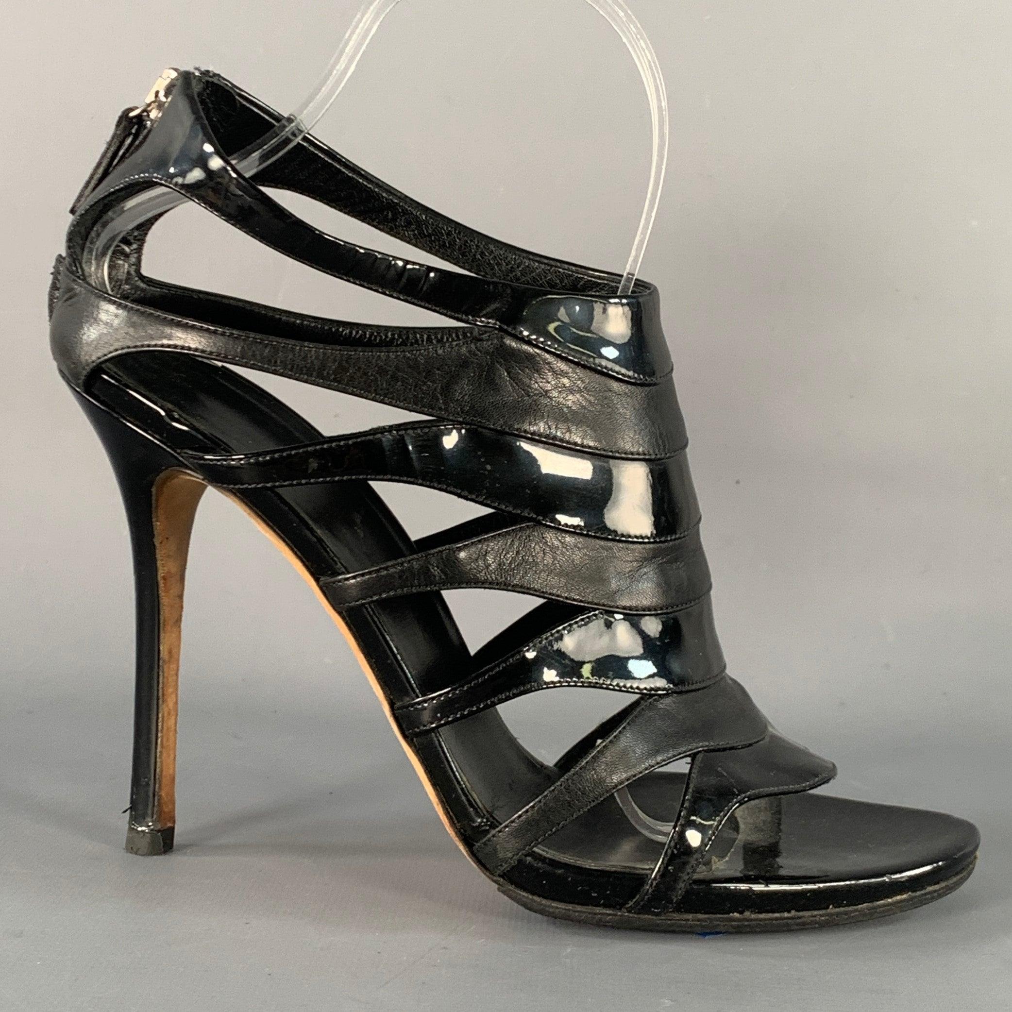 GUCCI sandals
in a black leather and patent leather featuring a cage design, stiletto heel, and back zipper closure. Made in Italy.Excellent Pre-Owned Condition. 

Marked:   258343 39.5 

Measurements: 
  Heel: 4.5 inches 
  
  
 
Sui Generis