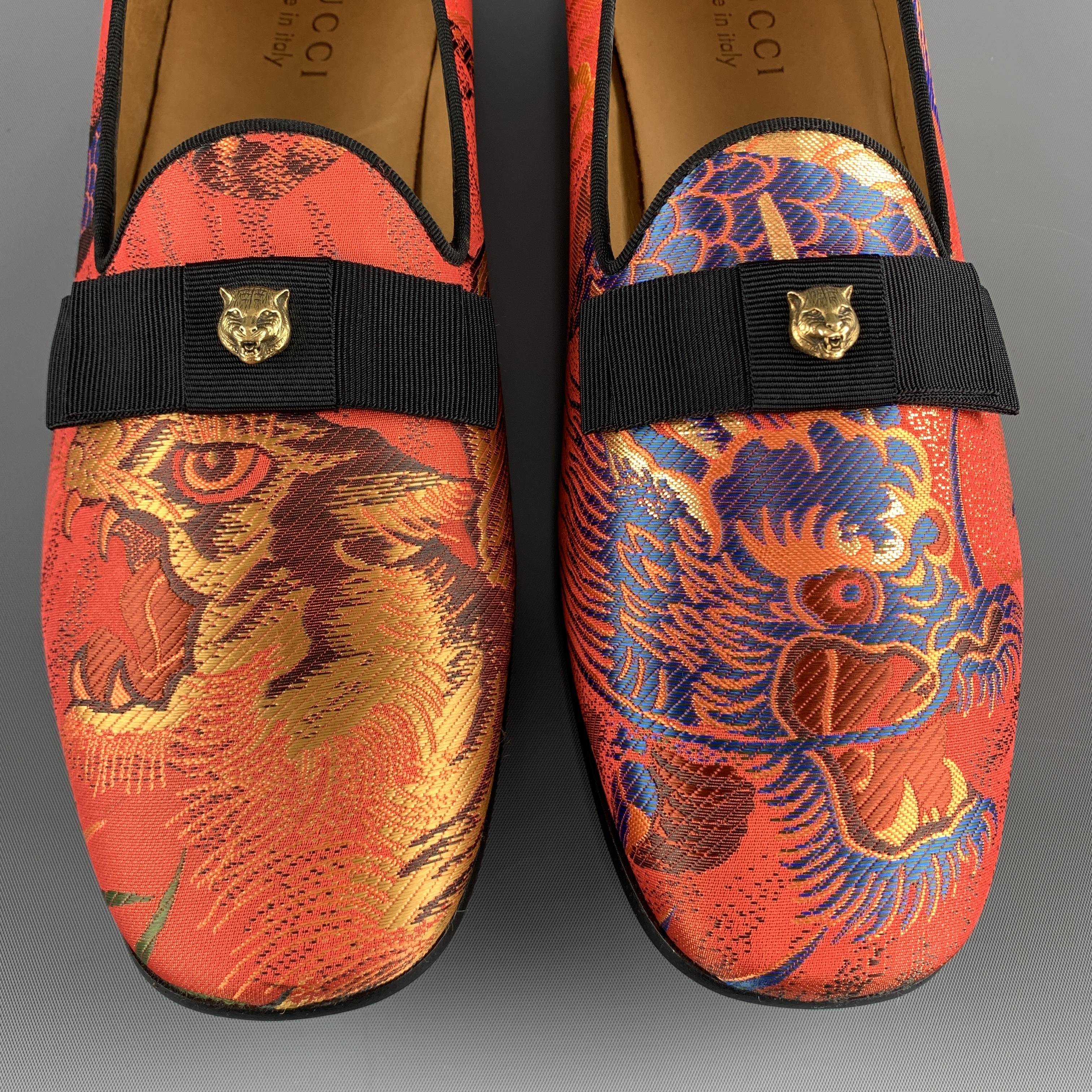 GUCCI dress loafers come in vibrant orange silk tiger & dragon print jacquard with black faille piping and ribbon bow detail with gold tone tiger stud accent. Made in Italy.

New in Box.
Marked: UK 9.5

Outsole: 11.65 x 3.75 in.