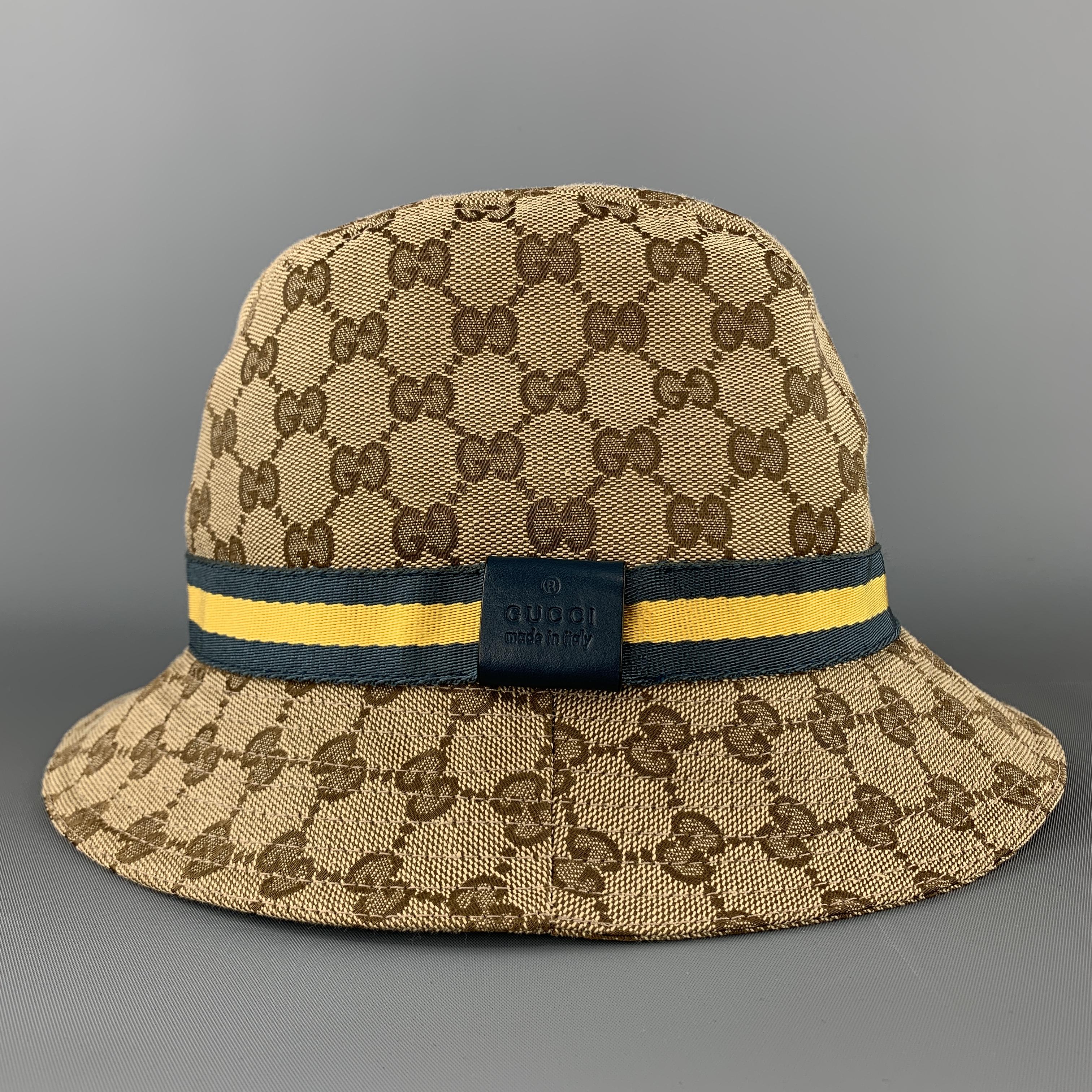 Vintage GUCCI bucket hat comes in classic beige Guccissima monogram canvas with a teal and yellow ribbon stripe. Made in Italy.

Excellent Pre-Owned Condition.
Marked: L

Measurements:

Opening: 22.5 in.
Brim: 2 in.
Height: 5 in.