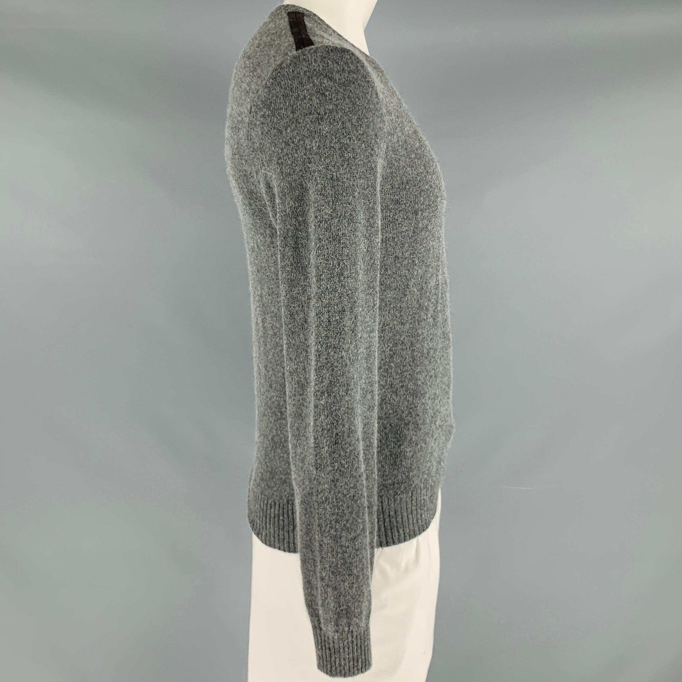 GUCCI sweater
in a grey alpaca blend knit featuring brown suede shoulder trim, blouson sleeves, and crew neck. Made in Italy.Excellent Pre-Owned Condition. 

Marked:   L 

Measurements: 
 
Shoulder: 17.5 inches Chest: 39 inches Sleeve: 28 inches