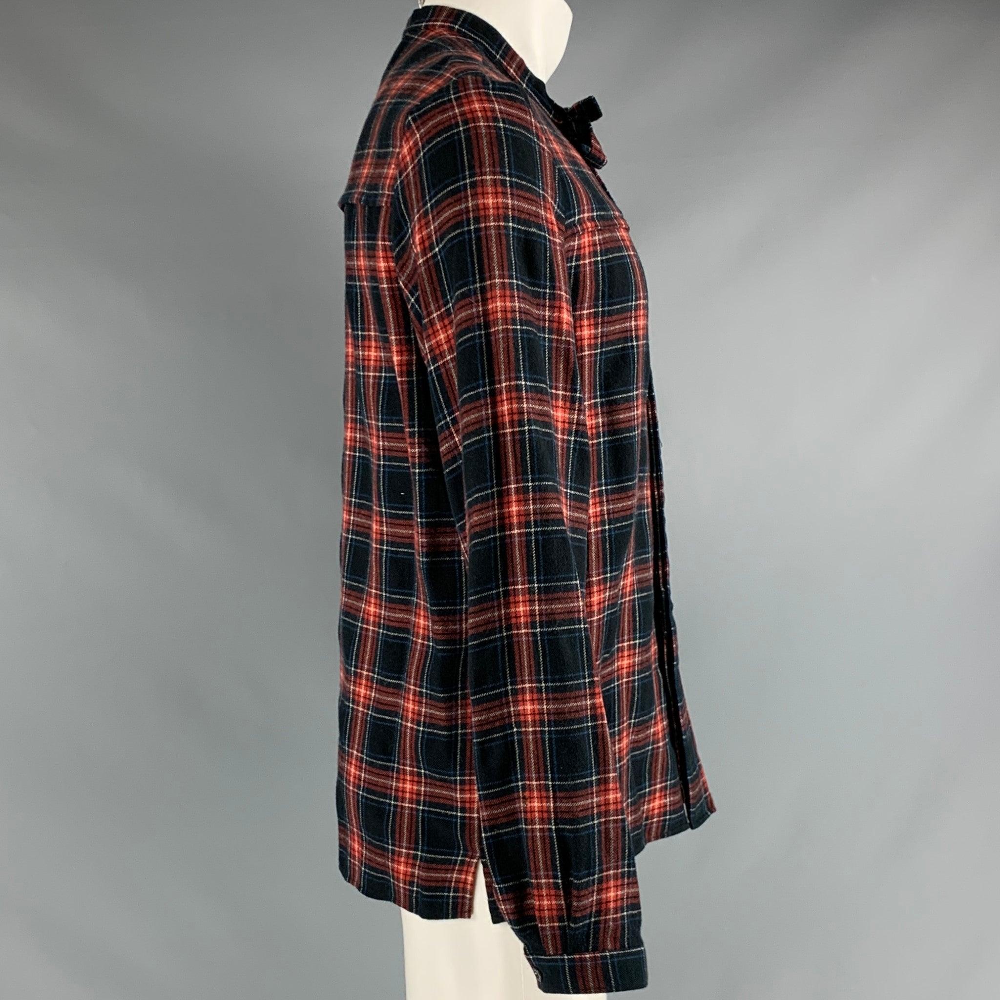 GUCCI long sleeve shirt
in a black red and blue cotton fabric featuring plaid pattern, neck bow, and hidden button closure. Made in Italy.Very Good Pre-Owned Condition. Minor signs of wear. 

Marked:   IT 50 

Measurements: 
 
Shoulder: 17.5 inches