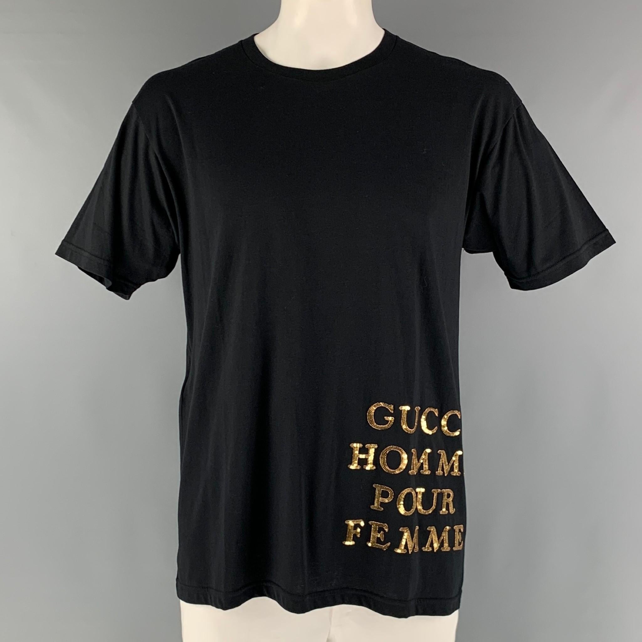 GUCCI oversized t-shirt comes in a black jersey cotton knit material featuring a gold tone embroidery phrase 