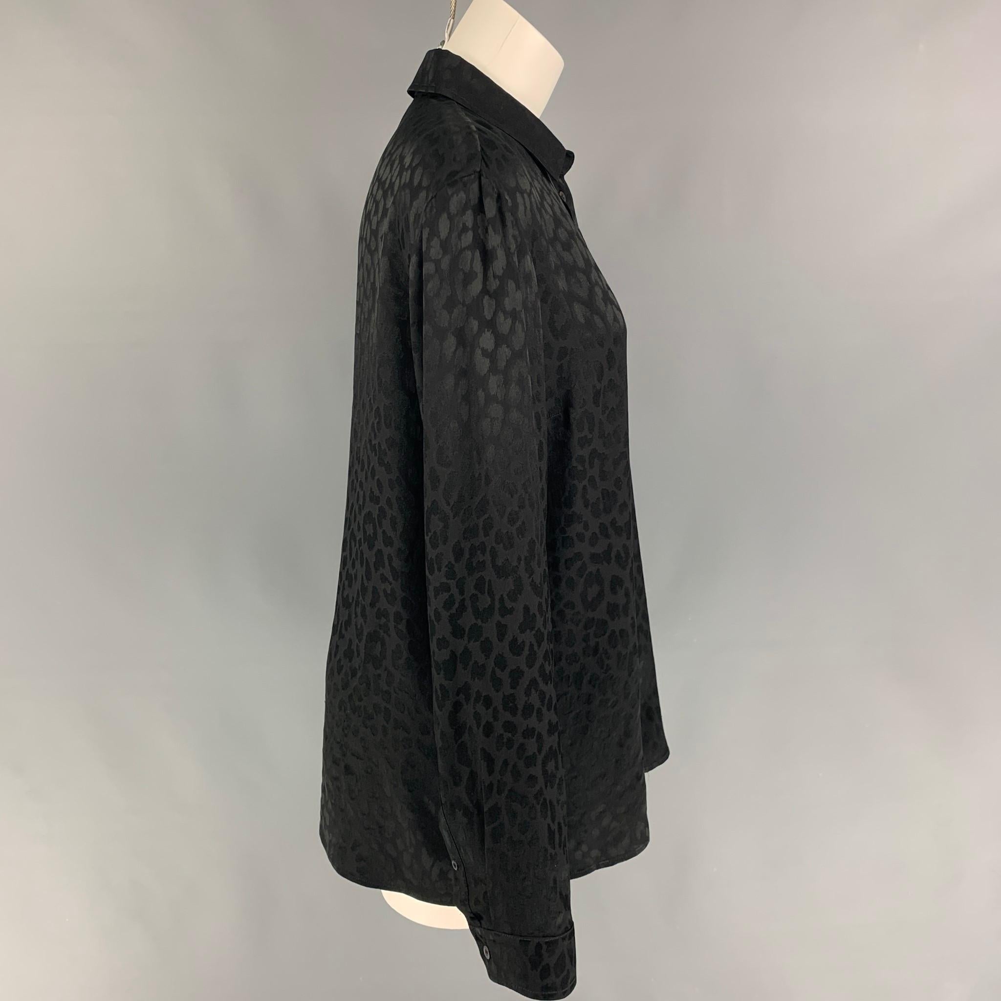 GUCCI shirt comes in a black animal print silk featuring a classic style, loose fit, spread collar, and a buttoned closure. Made in Italy. 

Excellent Pre-Owned Condition.
Marked: 48

Measurements:

Shoulder: 17.5 in.
Bust: 42 in.
Sleeve: 25.5