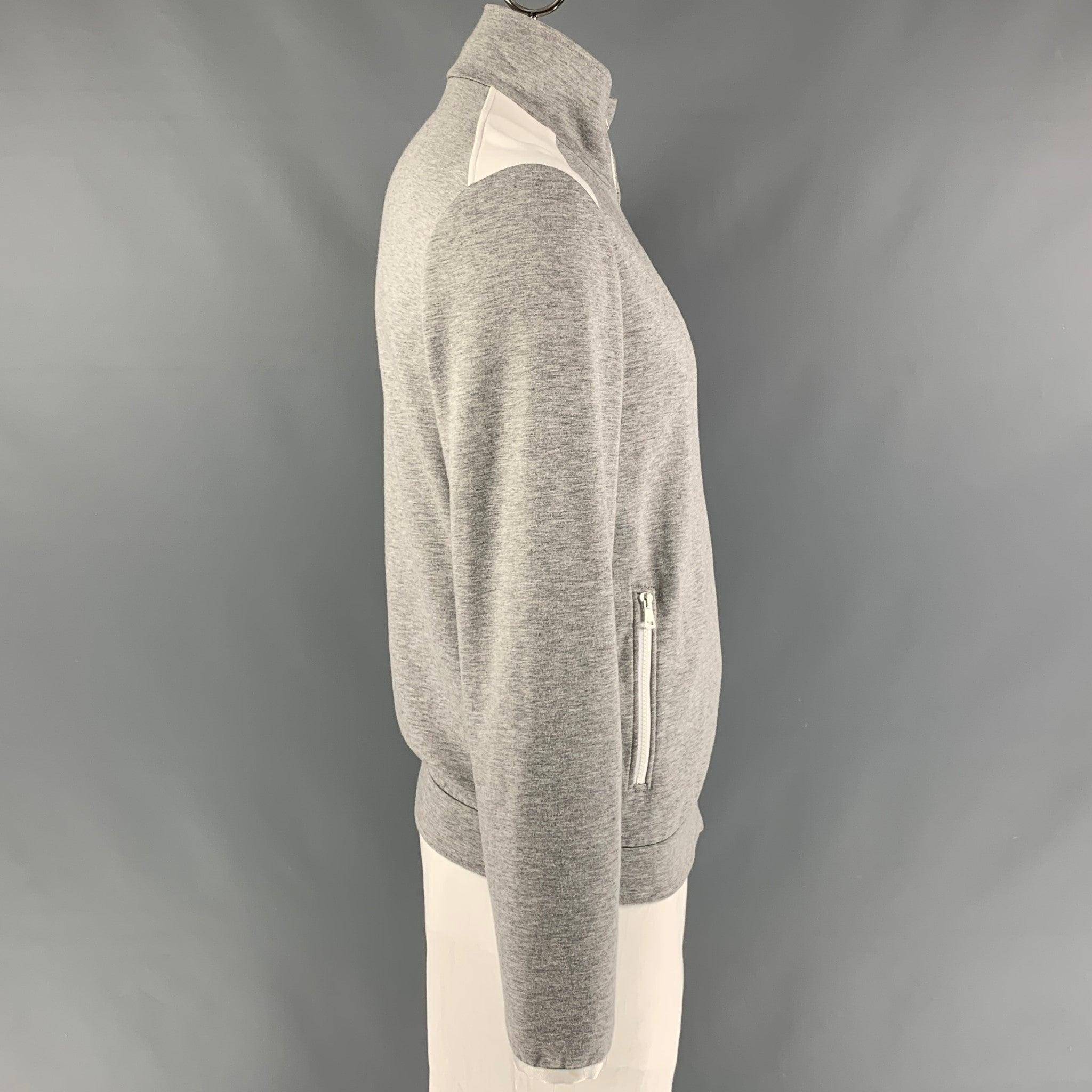 GUCCI sweatshirt comes in heather grey and white color block viscose blend featuring a high collar, zipper pocket, and a zip up closure. Made in Italy. Excellent Pre-Owned Condition. 

Marked:   XL 

Measurements: 
 
Shoulder: 20.5 inches Chest: 45