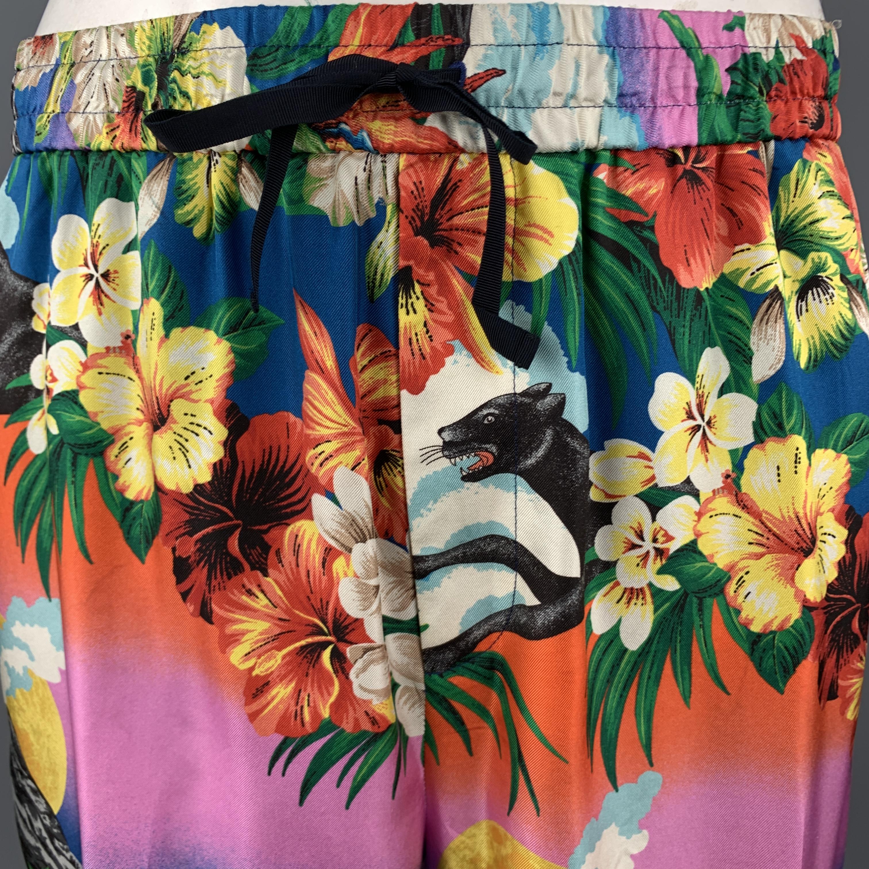 GUCCI shorts come in silk twill with a colorful floral, panther, volcano print , detailed with a drawstring, elactis waistband, and navy, red, and green striped ribbon trim. Light discolorations throughout. As-is. Matching shirt sold separately.
