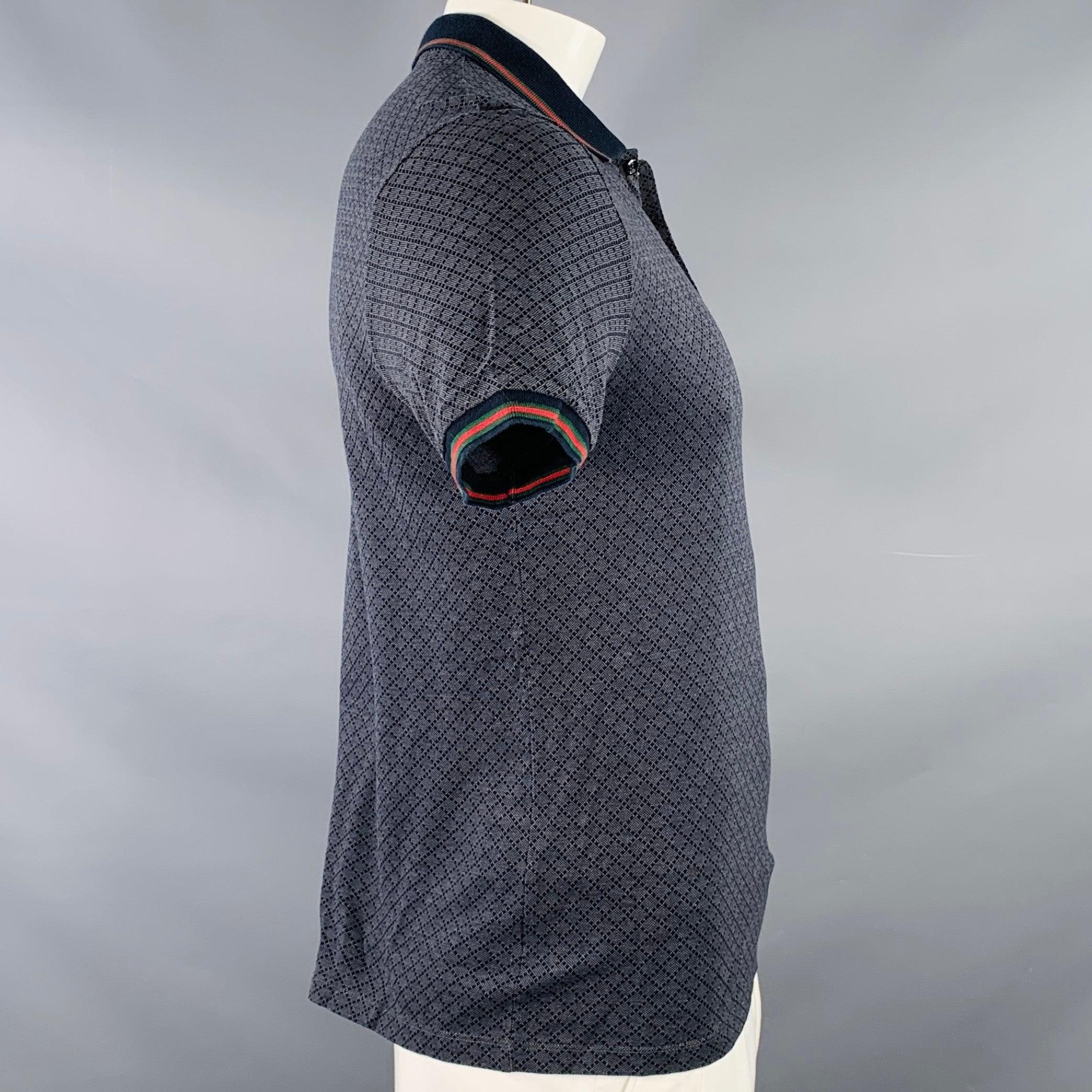 GUCCI polo in a navy and red cotton featuring a diamond grid pattern, contrasting navy with red and green stripe trim, and half placket button closure. Made in Italy.Excellent Pre-Owned Condition. 

Marked:   XL 

Measurements: 
 
Shoulder: 18