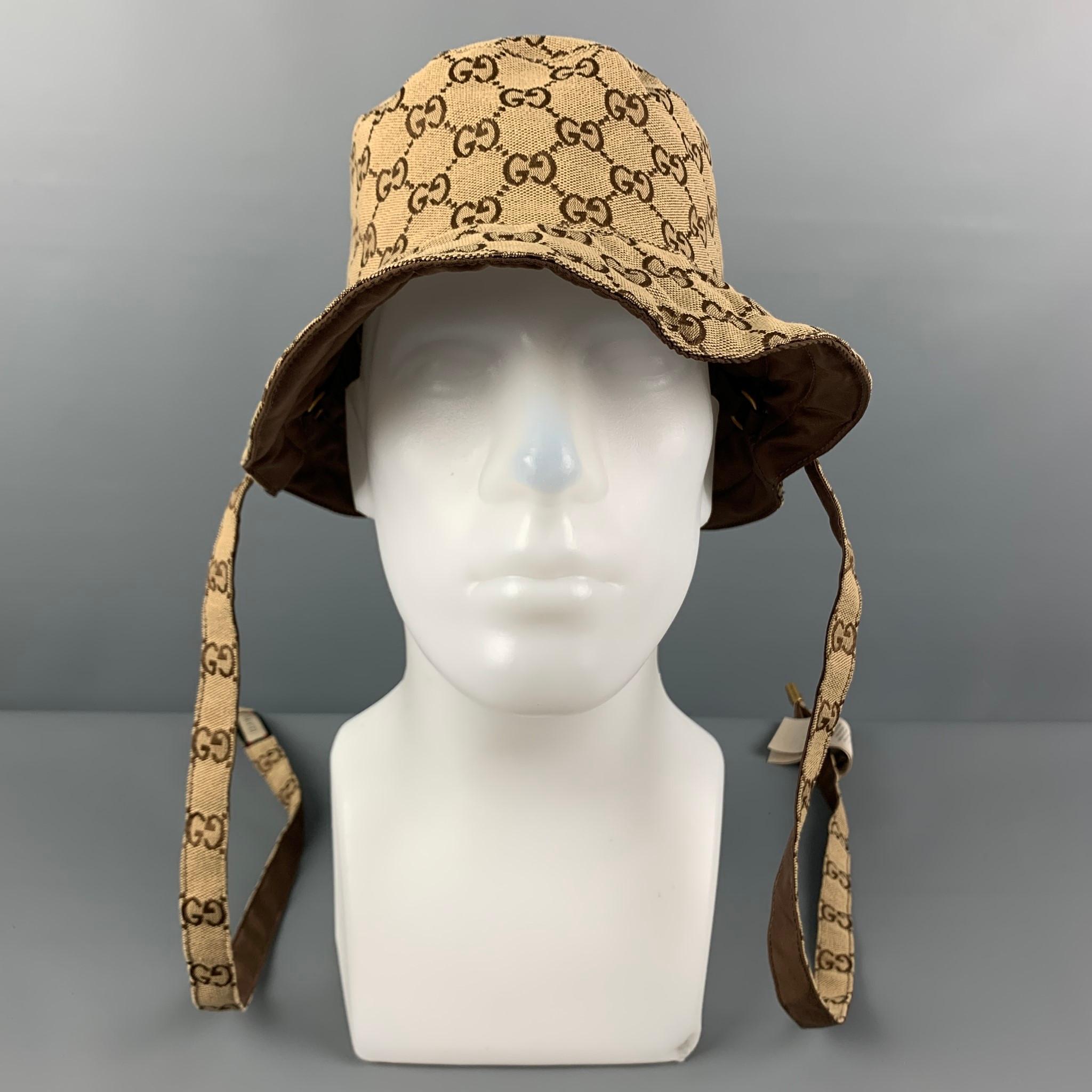 GUCCI bucket hat come in a tan & brown monogram canvas featuring a reversible style and long strap details. Includes dust bag. Made in Italy. 

Excellent Pre-Owned Condition.
Marked: XL

Measurements:

Opening: 22.5 in.
Brim: 2.5 in.
Height: 3.5 in.
