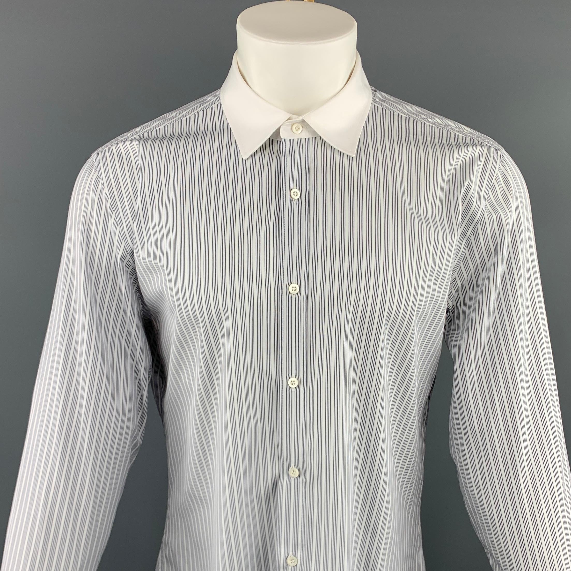 GUCCI long sleeve shirt comes in a white and black striped cotton featuring a button up style and a white spread collar. Made in Italy.
 
Excellent Pre-Owned Condition.
Marked: 44
 
Measurements:
 
Shoulder:18 in.
Chest: 47 in.
Sleeve: 27.5