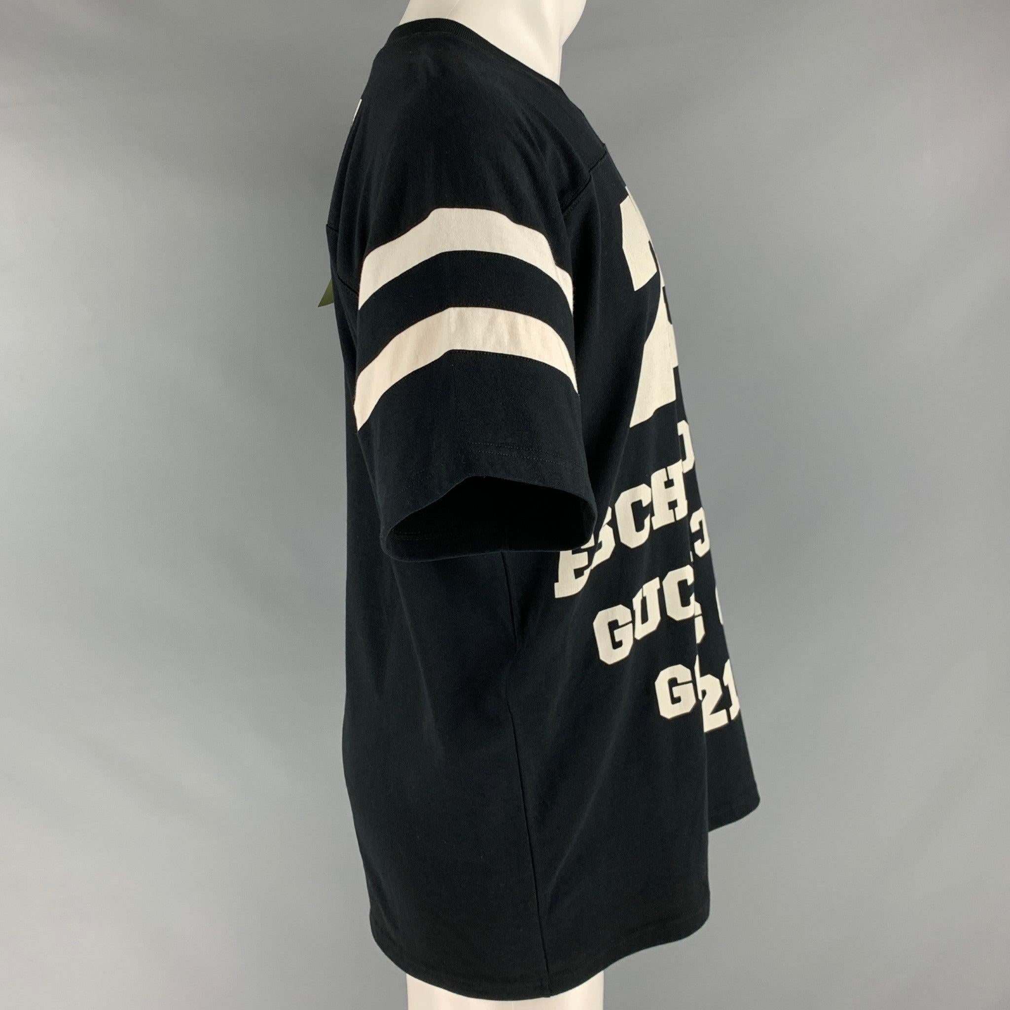 GUCCI t-shirt
in a black and white cotton fabric featuring white graphic text, athletic jersey style, and a crew neck. Made in Italy.New with Tags. 

Marked:   XS (160/84Y) 

Measurements: 
 
Shoulder: 17.5 inches  Chest: 43 inches  Sleeve: 10.5