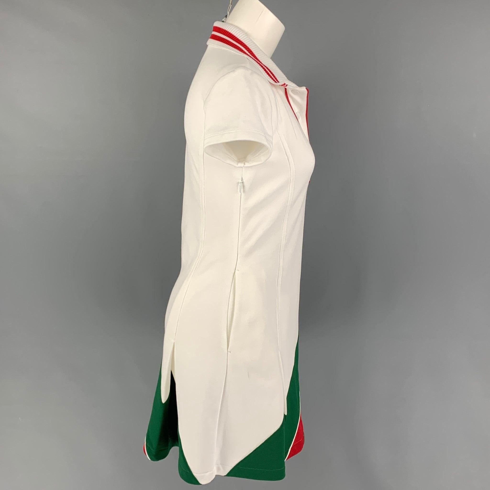 GUCCI 'Web Stripe' mini dress comes in a white pique cotton featuring a vintage tennis style, iconic web stripe, interlocking GG patch, spread collar, and a snap button closure. Made in Italy.
Very Good
Pre-Owned Condition. Light marks at front.