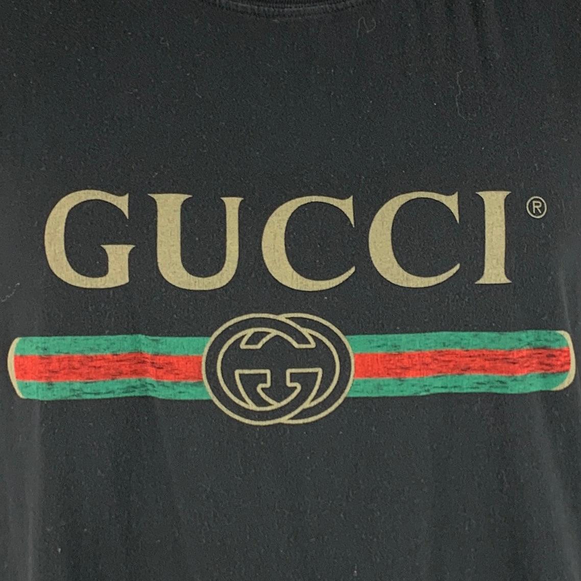 GUCCI t-shirt
in a black cotton fabric featuring signature logo print, and crew neck. Made in Italy.Excellent Pre-Owned Condition. 

Marked:   XXL 

Measurements: 
 
Shoulder: 23 inches Chest: 46 inches Sleeve: 9.5 inches Length: 28.5 inches 
  
  
