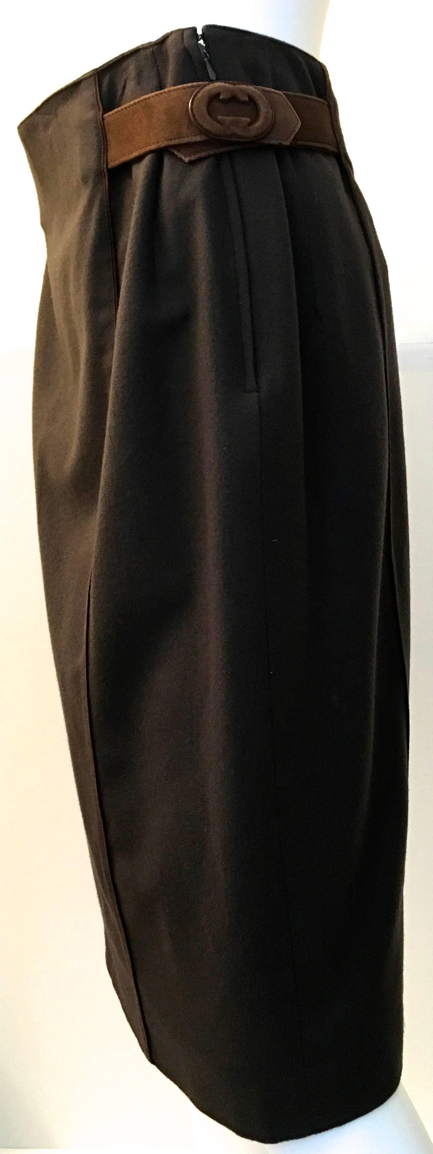 Presented here is a lovely skirt from Gucci. This vintage masterpiece is in mint condition and still has its original tags on it from the 1980's. The skirt is made of a soft brown wool and it is fully lined. There is a leather belt that is sewn into