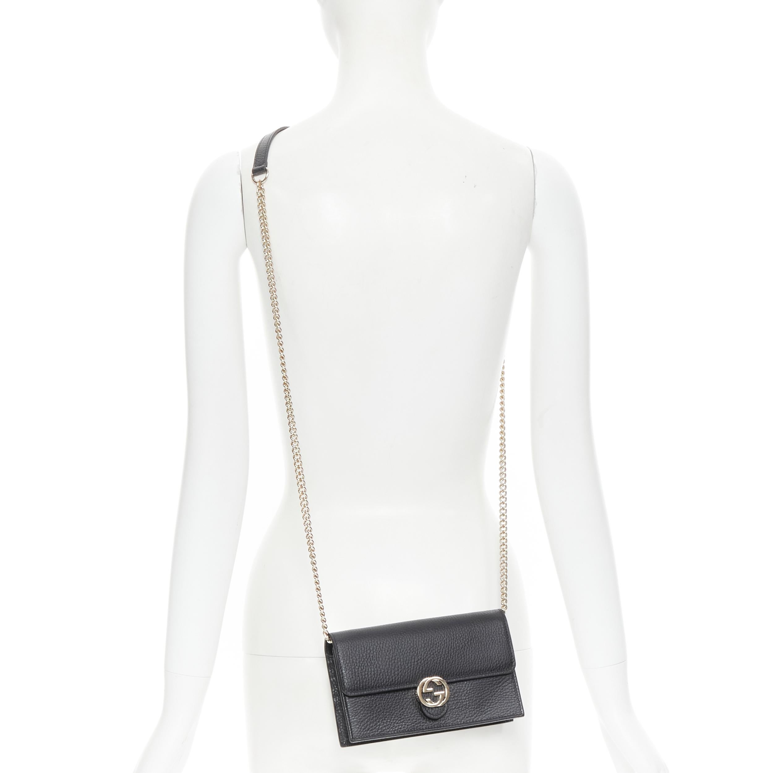 GUCCI Small Dollar black gold interlocking GG crossbody clutch wallet on chain 
Reference: TGAS/B01263 
Brand: Gucci 
Model: Interlocking GG flap crossbody 
Material: Leather 
Color: Black 
Pattern: Solid 
Closure: Button 
Extra Detail: Gold-tone