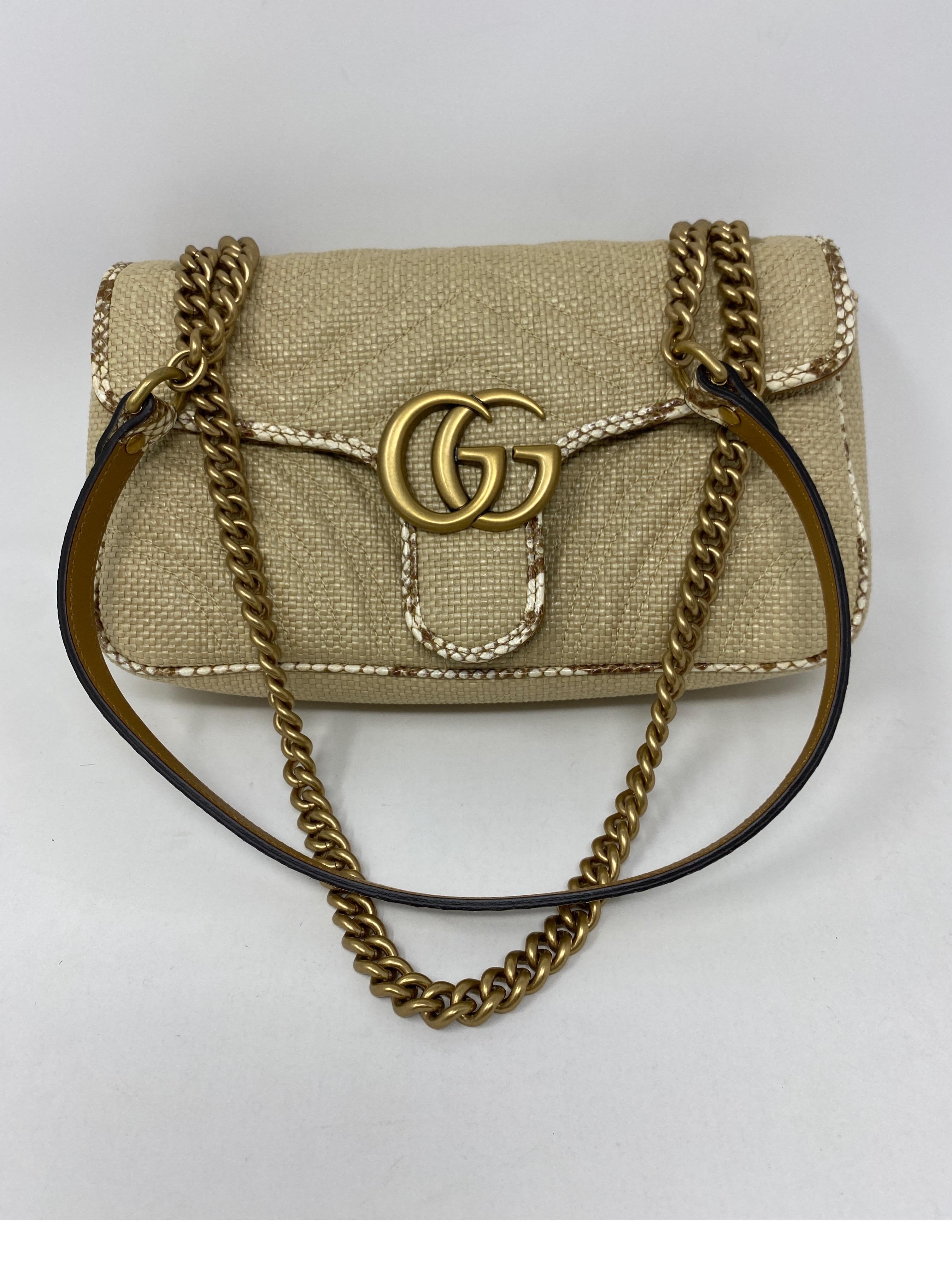Gucci Small Marmont Straw Bag. Python style leather trim. Mint like new condition. Beautiful bag. Guaranteed  authentic. Dark tan leather interior and floral pattern material. Includes Gucci dust cover. 