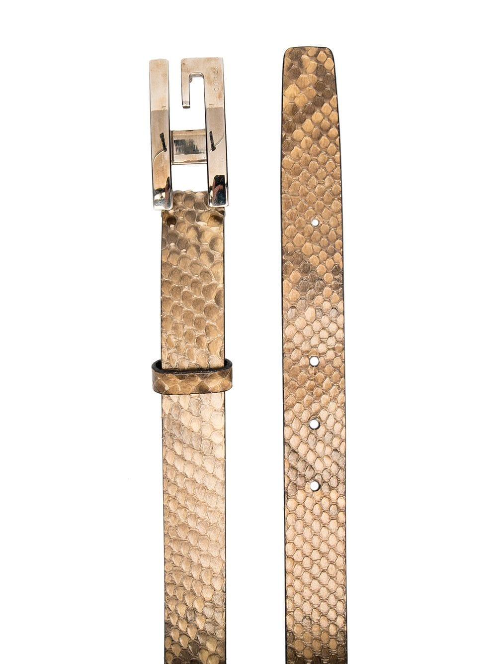 Crafted in Italy from an intricate combination of beige and brown snake-print leather, this pre-owned belt by Gucci features an adjustable fit, a slim design and the signature 'GG' logo buckle accented by silver-toned metal hardware.

Colour: Beige/