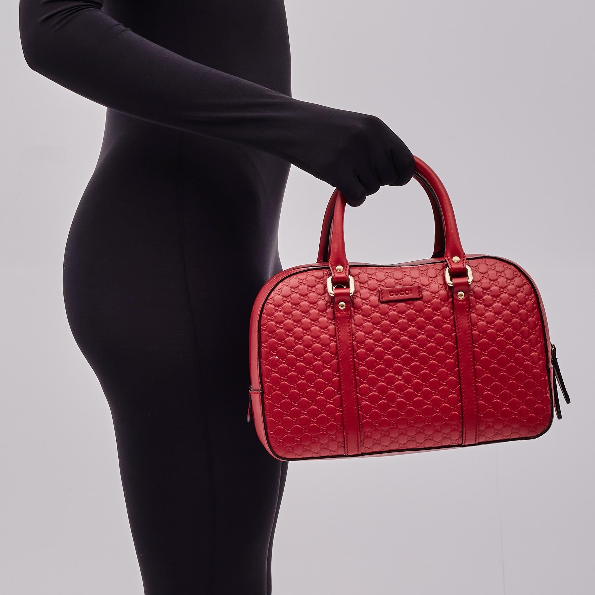 This bag is made of microguccissima soft leather in red. Microguccissima is Gucci’s monogram-embossed leather. The bag features dual rolled leather top handles and an optional adjustable leather shoulder strap. The light gold wrap-around zipper
