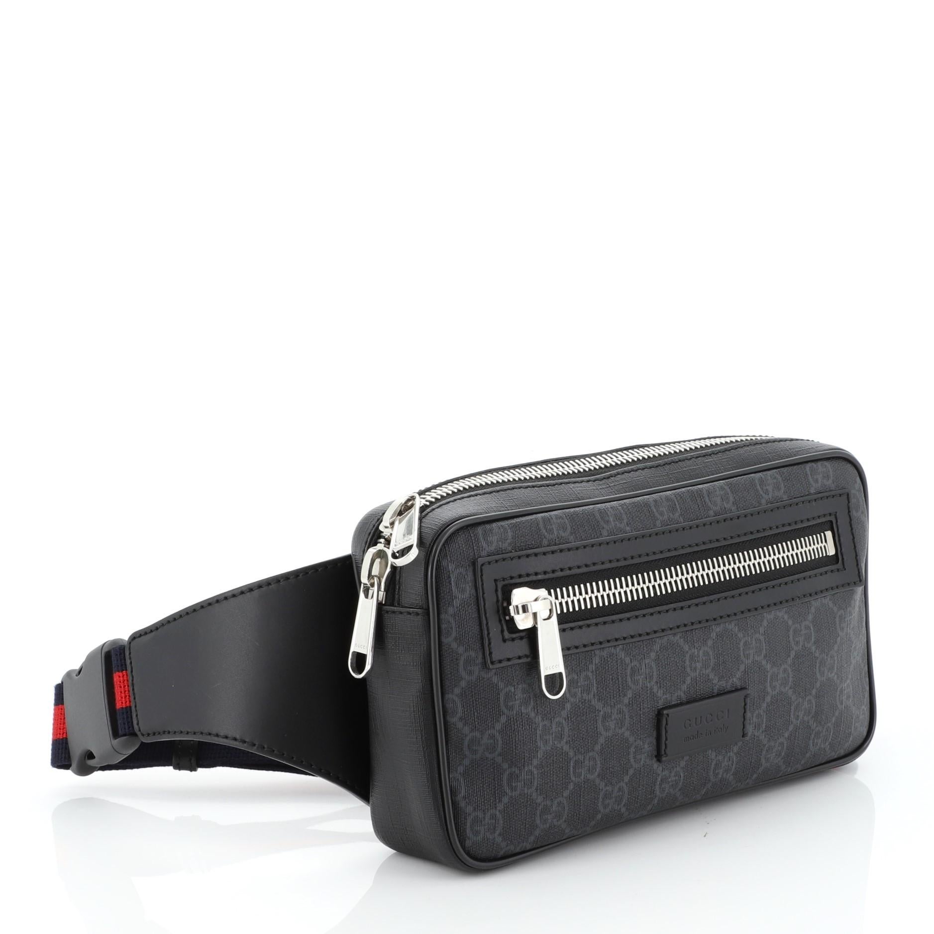 This Gucci Soft Zip Belt Bag GG Coated Canvas Small, crafted in black GG coated canvas, features an adjustable web belt strap, leather trim, exterior front zip pocket and silver-tone hardware. Its zip closure opens to a black fabric interior with