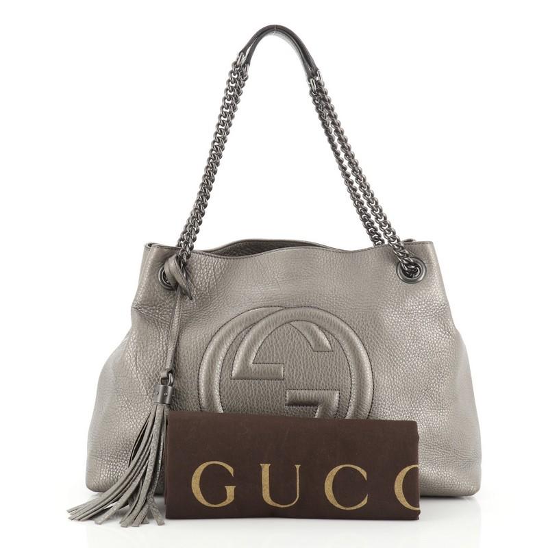 This Gucci Soho Chain Strap Shoulder Bag Leather Medium, crafted in gray leather, features chain link straps with leather pads and matte gunmetal-tone hardware. Its hook clasp closure opens to a neutral fabric interior with side zip and slip