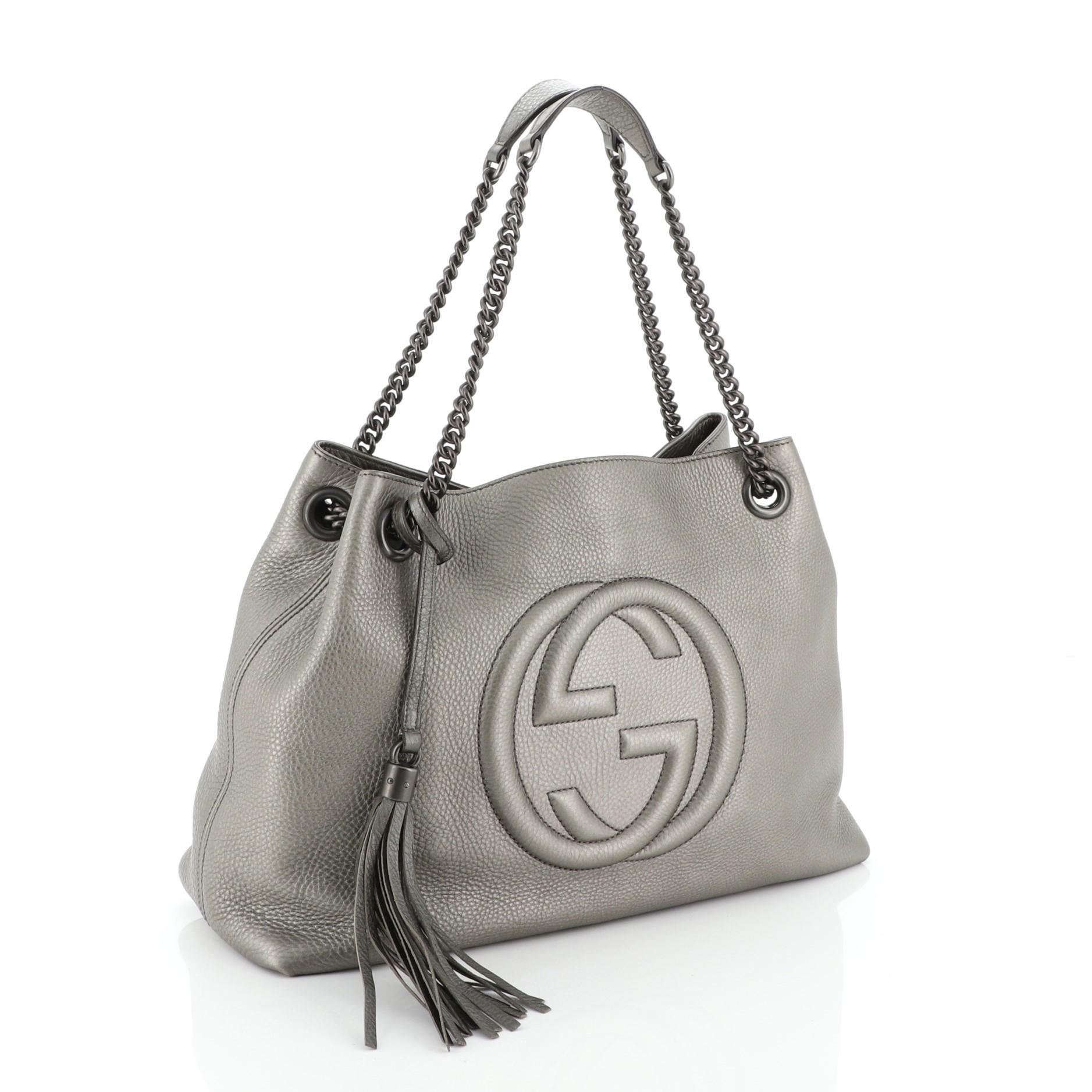This Gucci Soho Chain Strap Shoulder Bag Leather Medium, crafted in gray leather, features chain link straps with leather pads and gunmetal-tone hardware. Its hook clasp closure opens to a neutral fabric interior with side zip and slip pockets.
