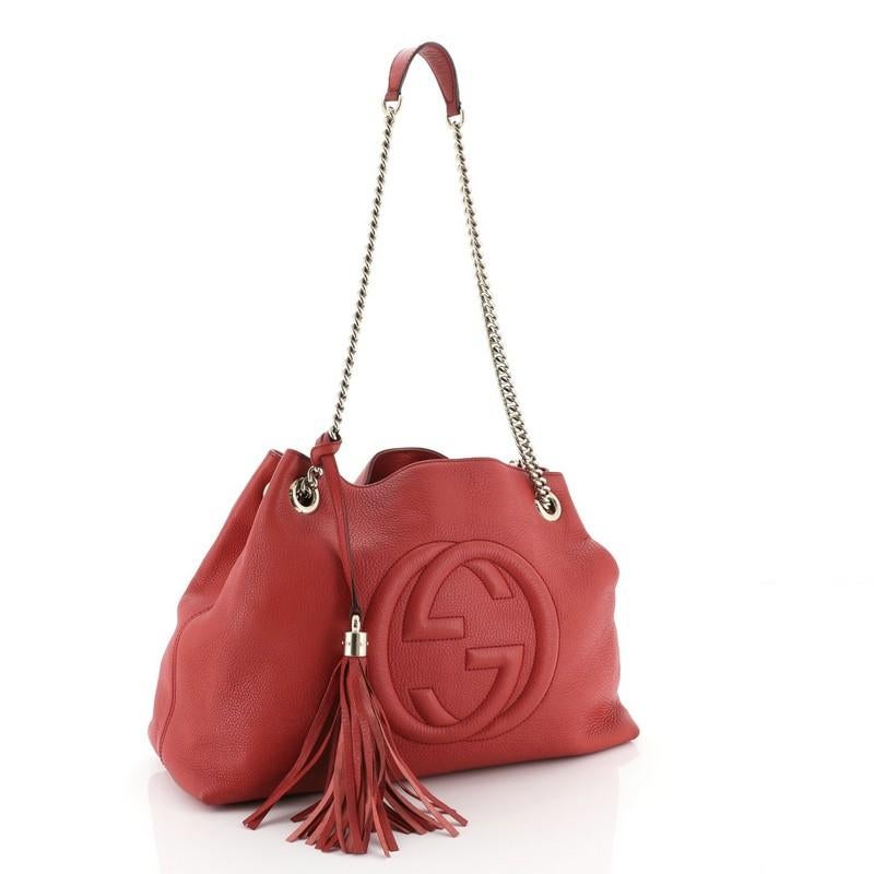 This Gucci Soho Chain Strap Shoulder Bag Leather Medium, crafted in red leather, features chain link straps with leather pads and gold-tone hardware. Its hook clasp closure opens to a neutral fabric interior with side zip and slip pockets.