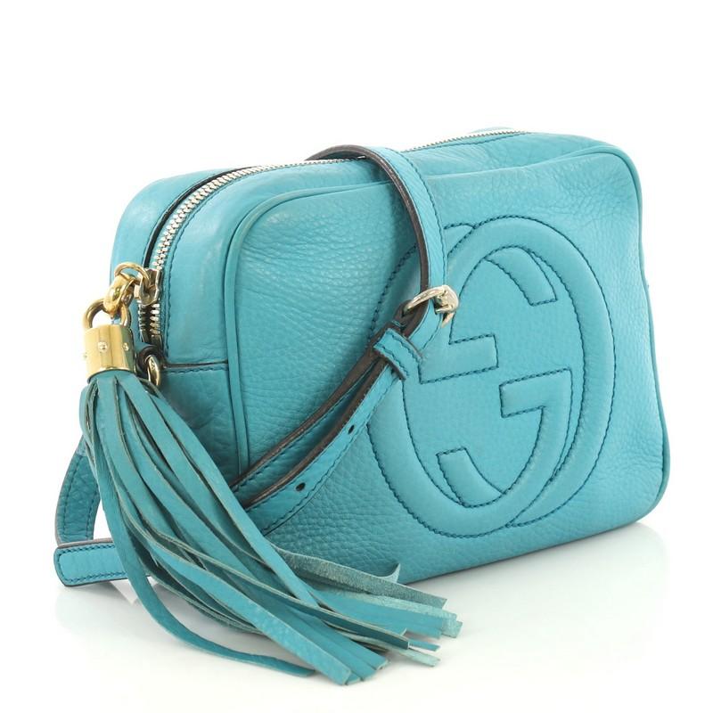 This Gucci Soho Disco Crossbody Bag Leather Small, crafted in blue leather, features an adjustable leather strap, tassel zip pull, and gold-tone hardware. Its zip closure opens to a neutral canvas interior with slip pockets. 

Estimated Retail