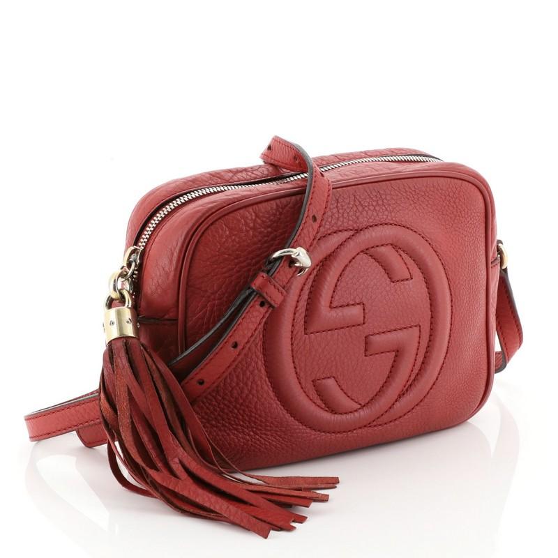 This Gucci Soho Disco Crossbody Bag Leather Small, crafted in red leather, features an adjustable leather strap, tassel zip pull, and gold-tone hardware. Its zip closure opens to a neutral fabric and canvas interior with slip pockets. 

Estimated