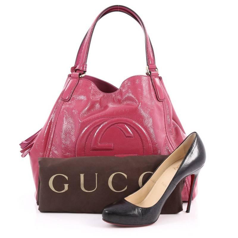 This authentic Gucci Soho Shoulder Bag Patent Medium is a fresh casual-chic tote made for everyday excursions. Crafted from fuchsia patent leather, this no-fuss tote features Gucci's signature interlocking GG logo stitched at the front, dual looped