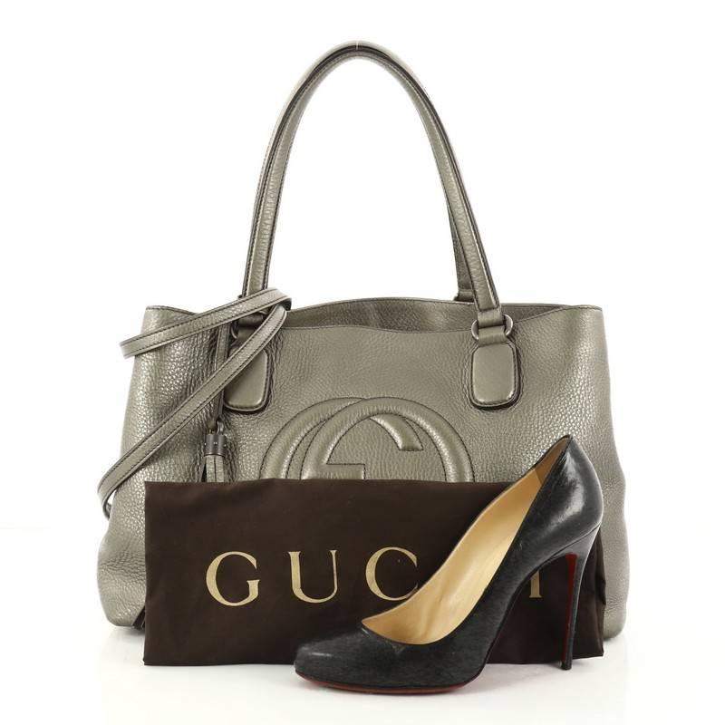 This authentic Gucci Soho Working Tote Leather Medium is perfect for any casual or sophisticated outfit. Crafted from pewter grey leather, this elegant tote features dual thin tall handles, stitched interlocking GG logo, protective base studs, and