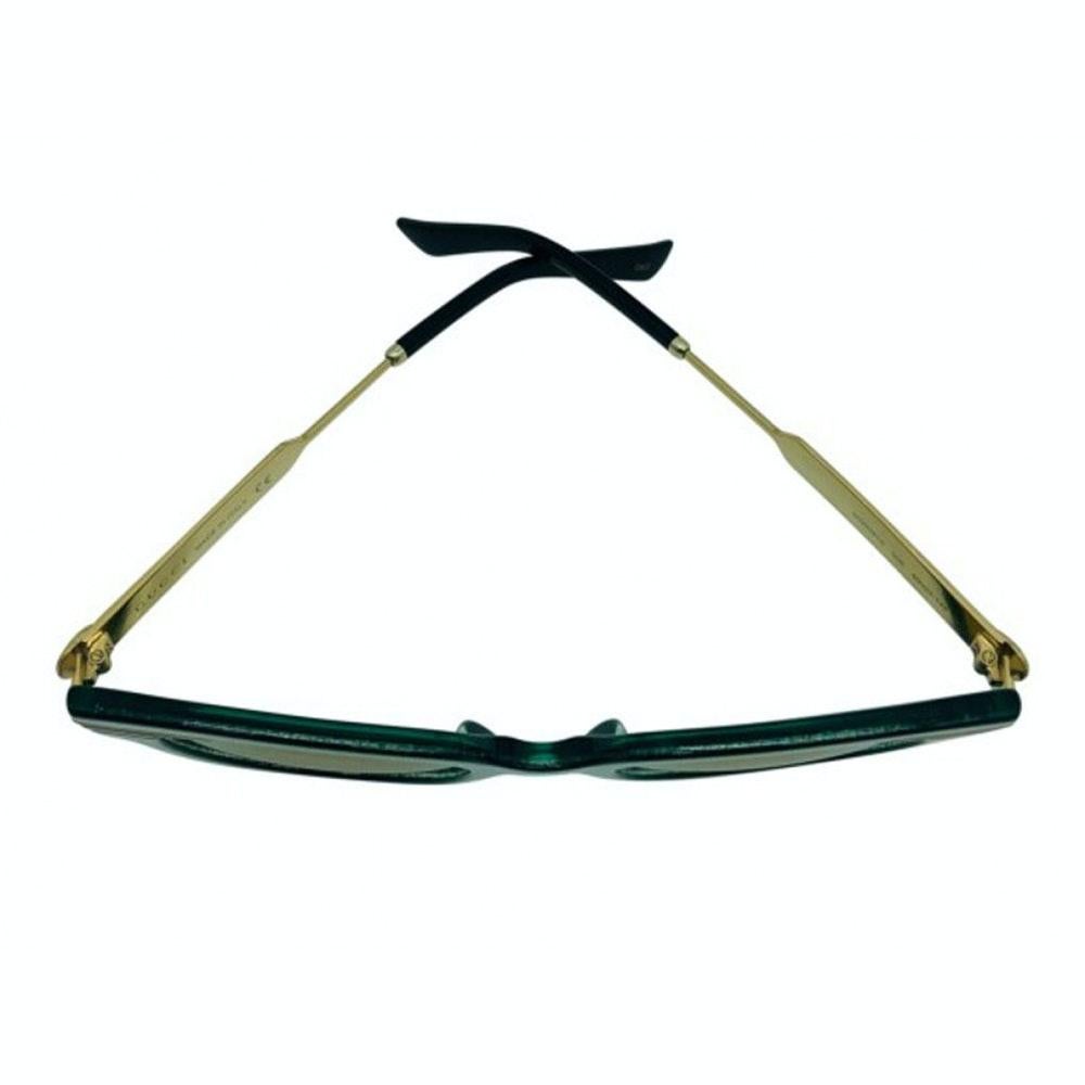 A lovely pair of Gucci sunglasses in a geometric shape with references to pop culture and Optical Art. Emerald Green Glitter Acetate and Gold Square. A preloved item in excellent condition.

BRAND	
Gucci

ACCESSORIES	
Case, cleaning